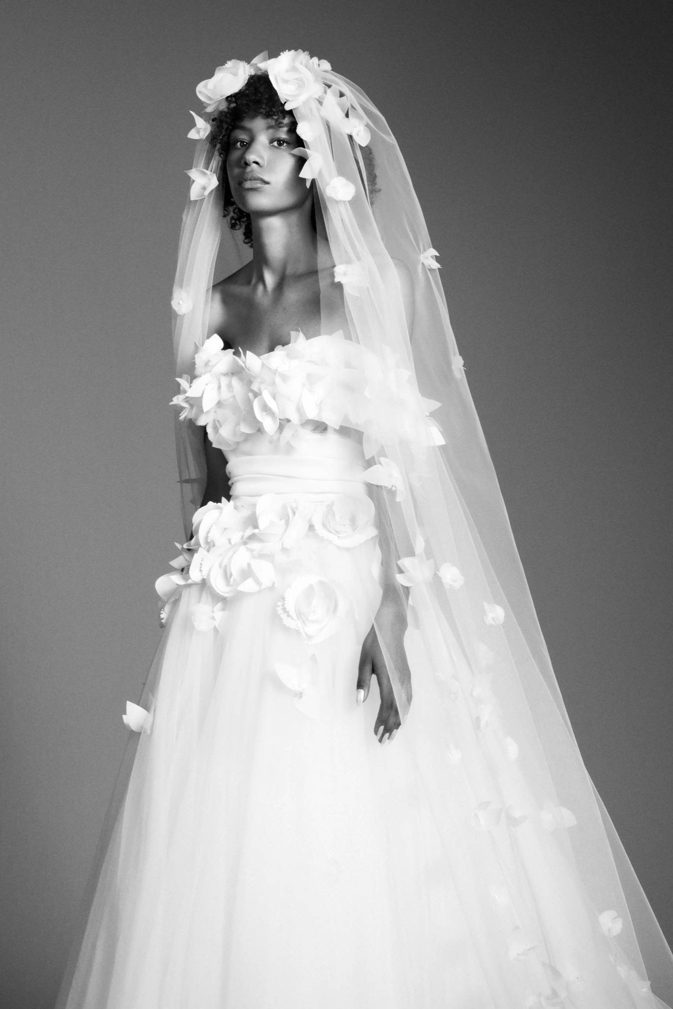 Dramatic veil adorned by beautifully crafted organza flowers, depicting a romantic garden on a sheer tulle canvas, from the Viktor&Rolf Mariage collection.