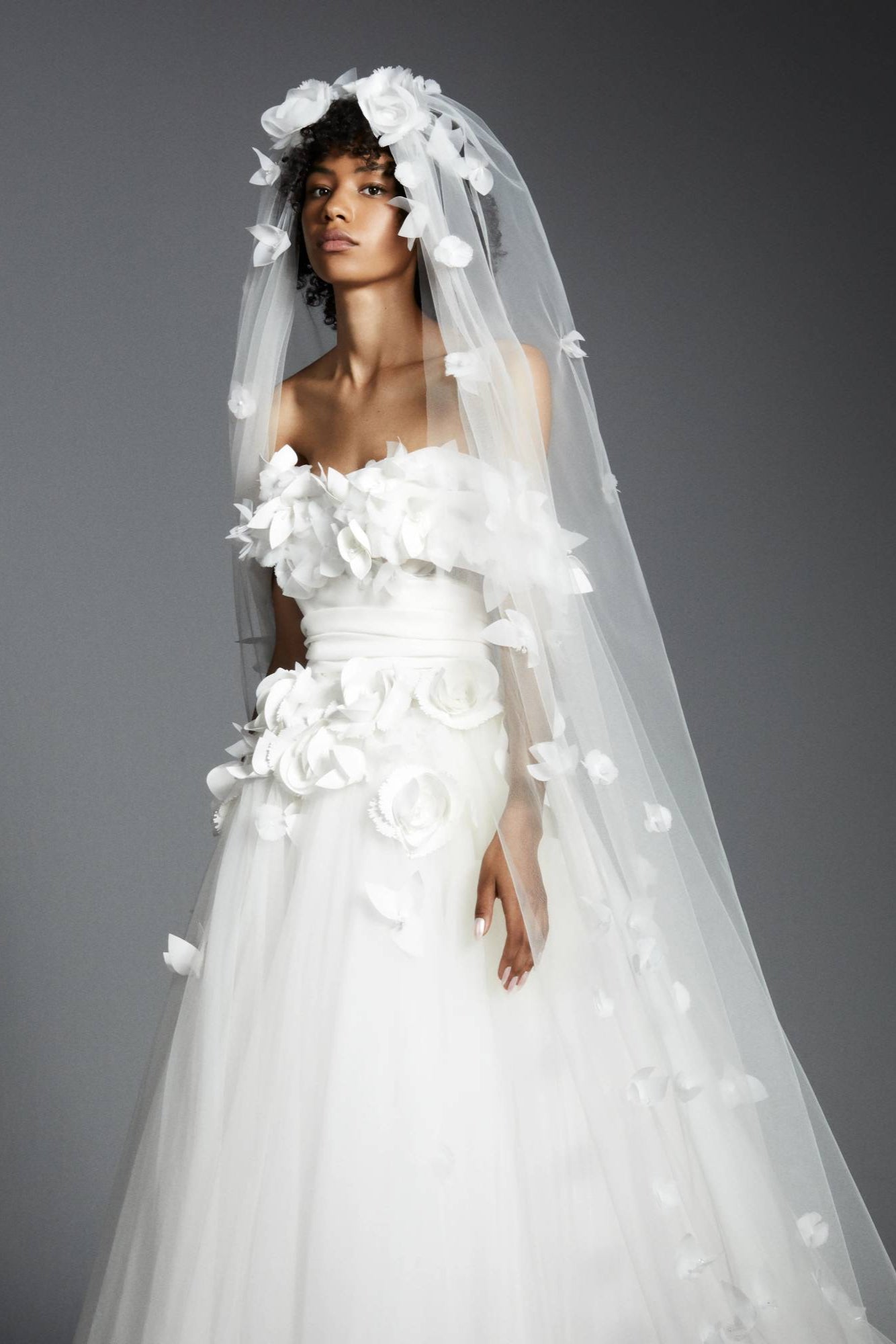 Dramatic veil adorned by beautifully crafted organza flowers, depicting a romantic garden on a sheer tulle canvas, from the Viktor&Rolf Mariage collection.