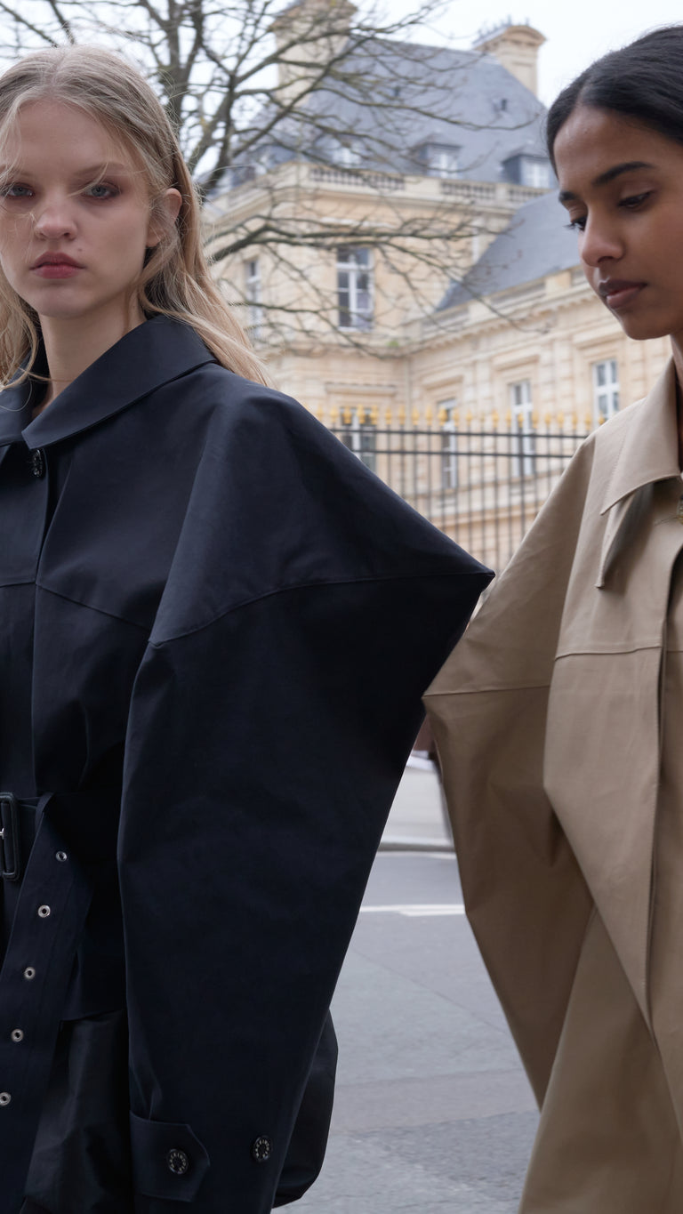Two models wearing jackets in the streets of Paris