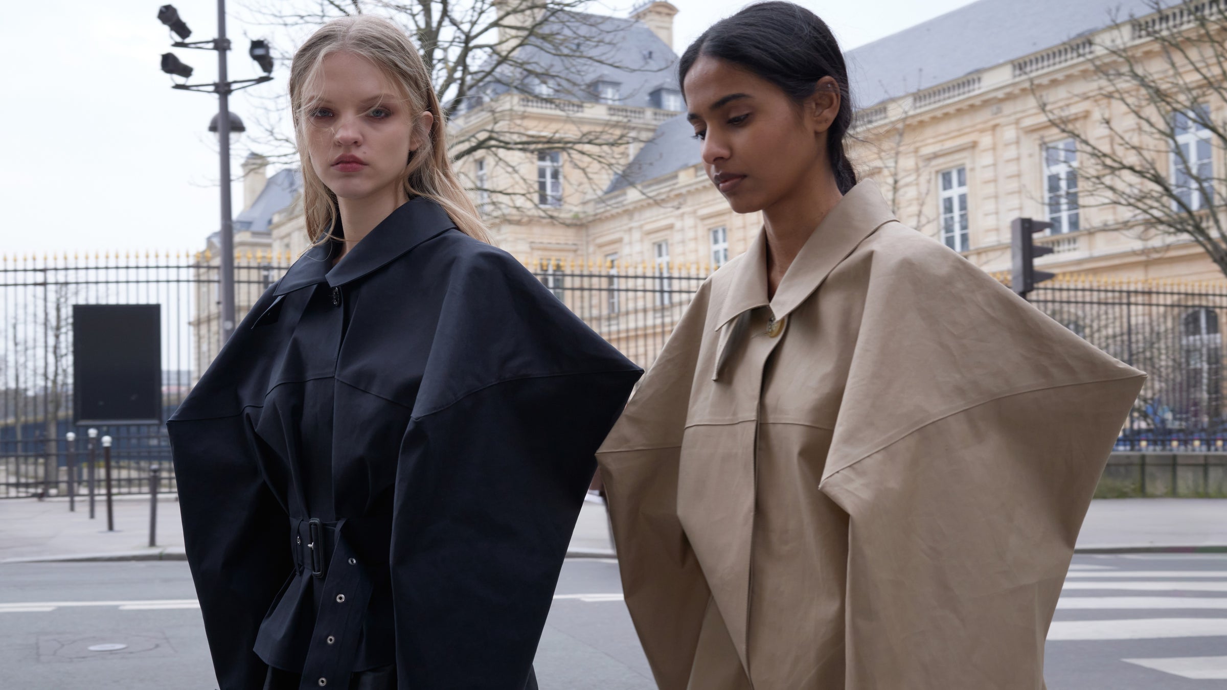 Two models wearing jackets in the streets of Paris