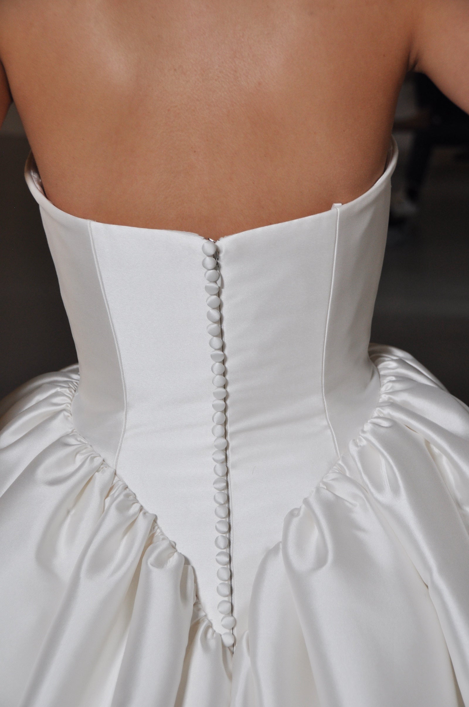 Close-up shot on a detail of the back of a wedding gown.