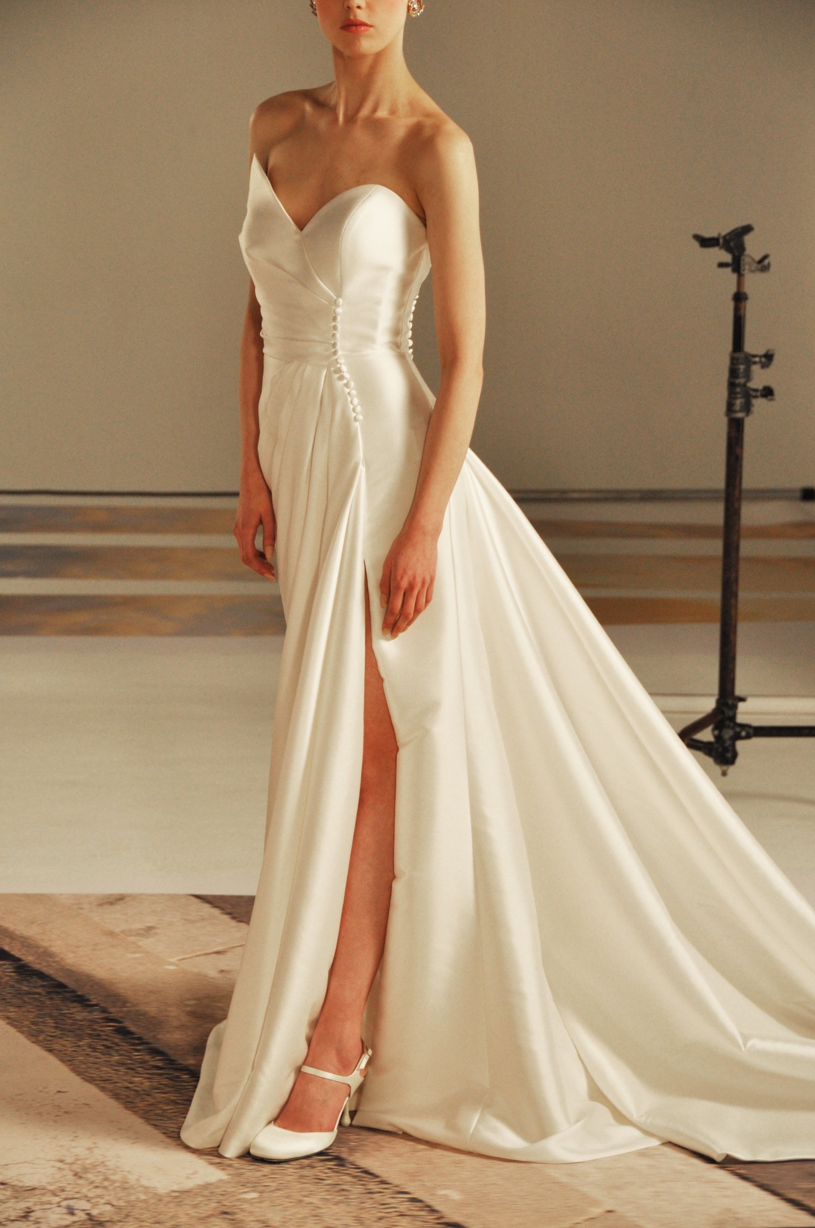 Model wearing a white strapless bridal gown.