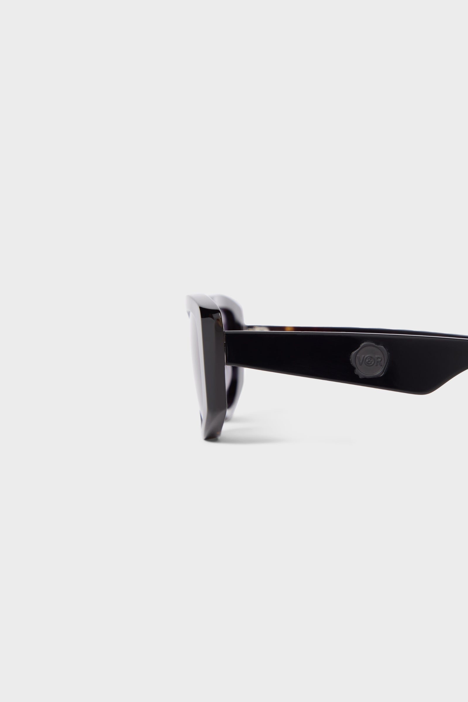 Semi-oval black sunglasses on a white background.