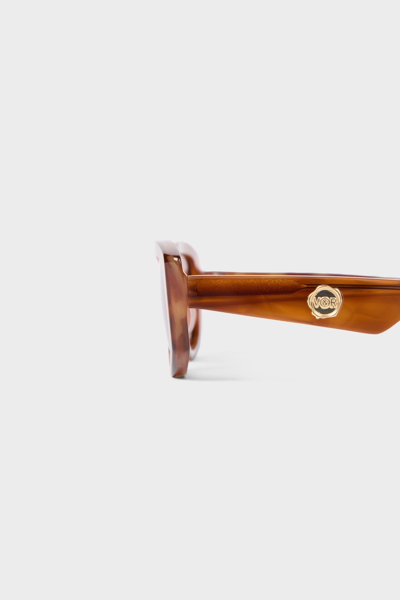 Closeup on light tortoise sunglasses on a white background.