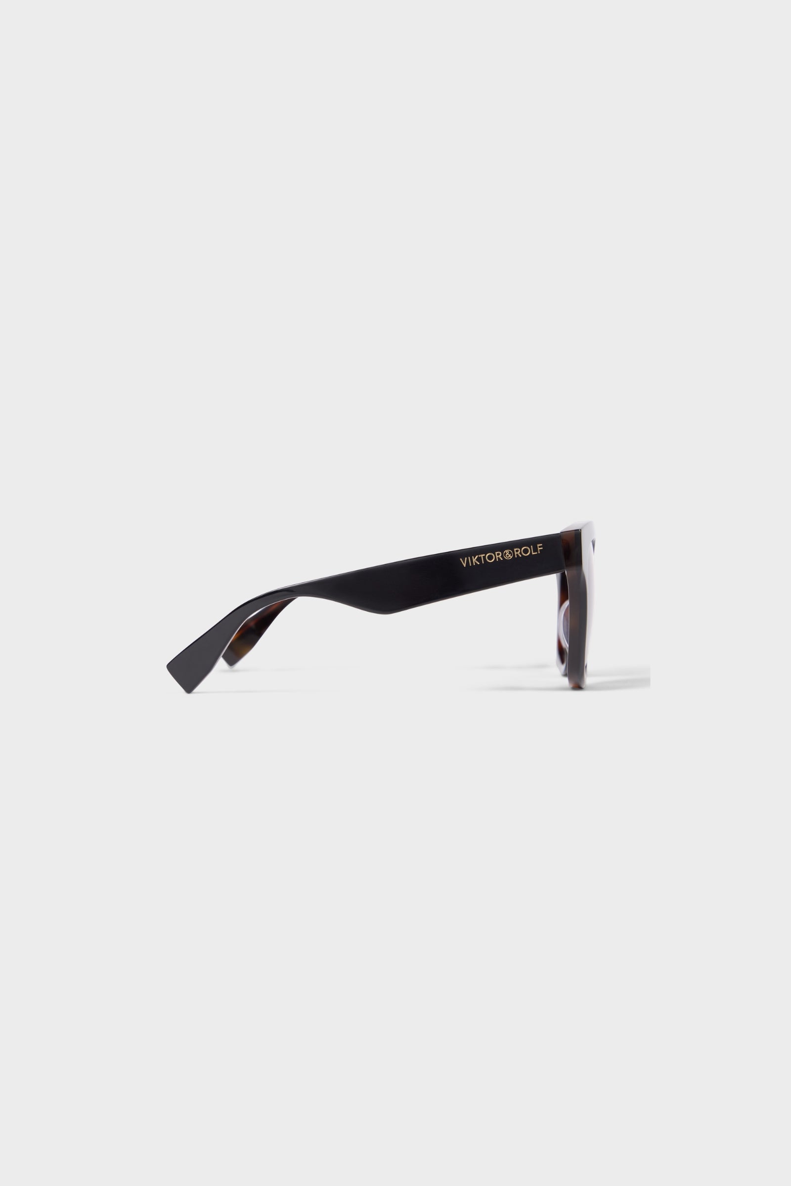 Sleek tortoiseshell sunglasses with oversized frames and gradient brown lenses, perfect for a chic and stylish look. Shown from the side.