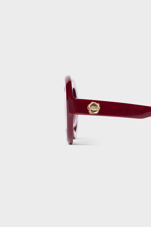 Burgundy round glasses close up.
