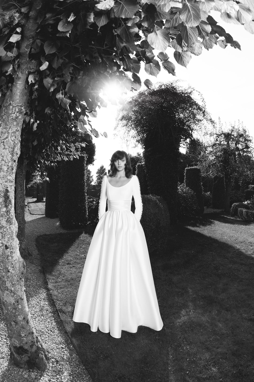 Viktor & Rolf Mariage Bridalwear Collection Sophisticated Sabrina gown, elegant white satin with timeless silhouette.