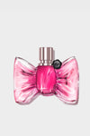 Pink bow-shaped perfume bottle on a light gray background