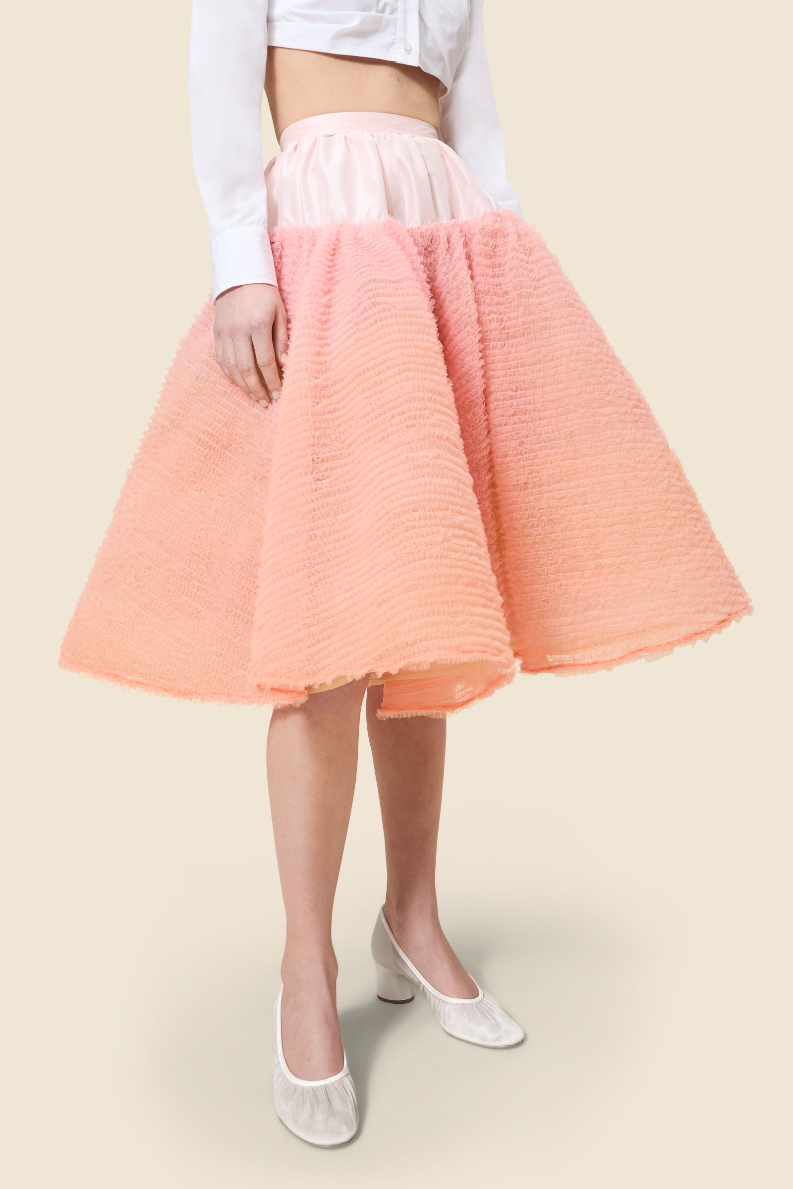 Inspired by the tulle from the ‘late stage capitalism waltz’ haute couture collection, the skirt features hand crafted tulle ruffles for a feminine texture