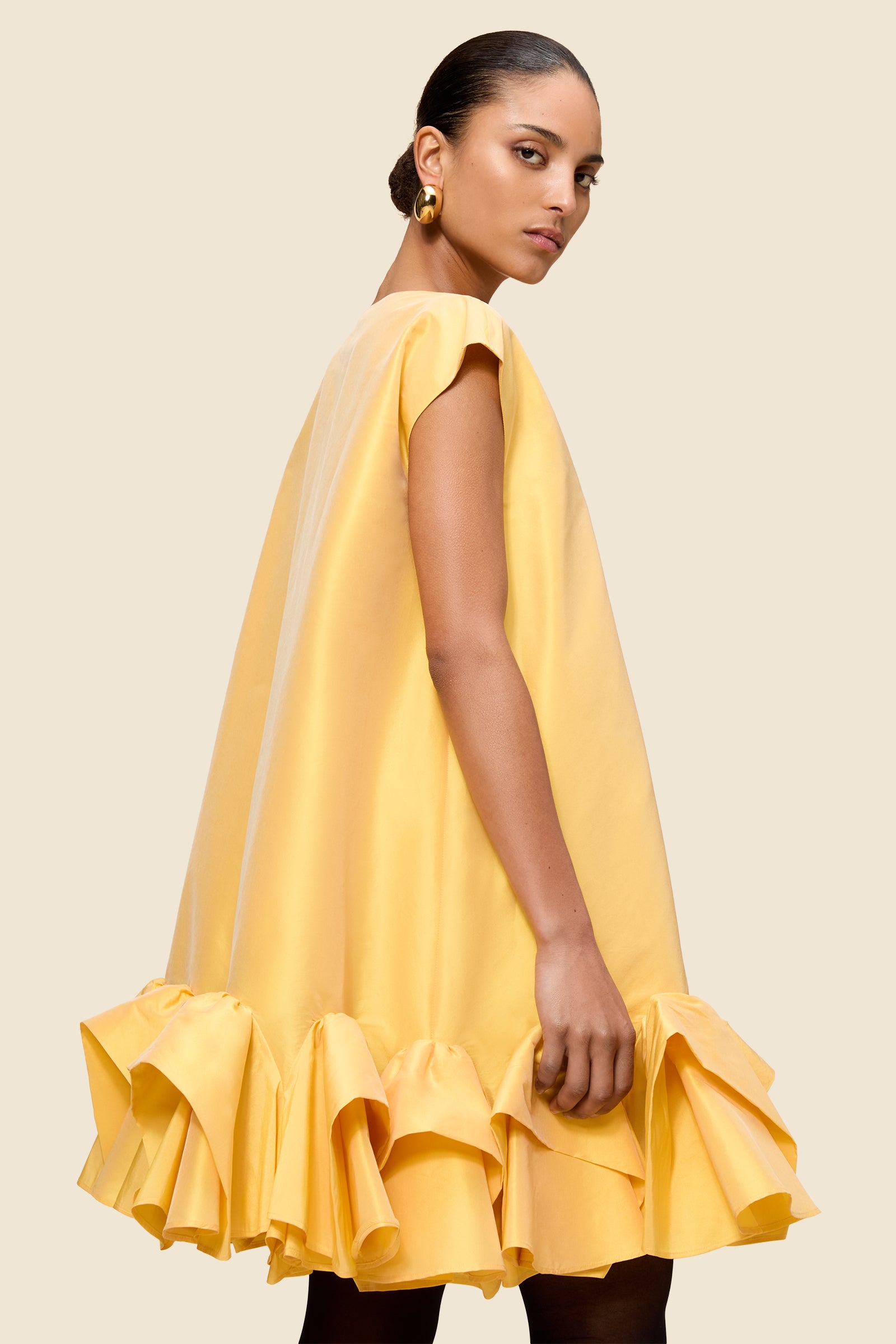 The craftmanship of the dress reinterprets classic haute couture tuck ups into a modern silhouette from silk-blend taffeta