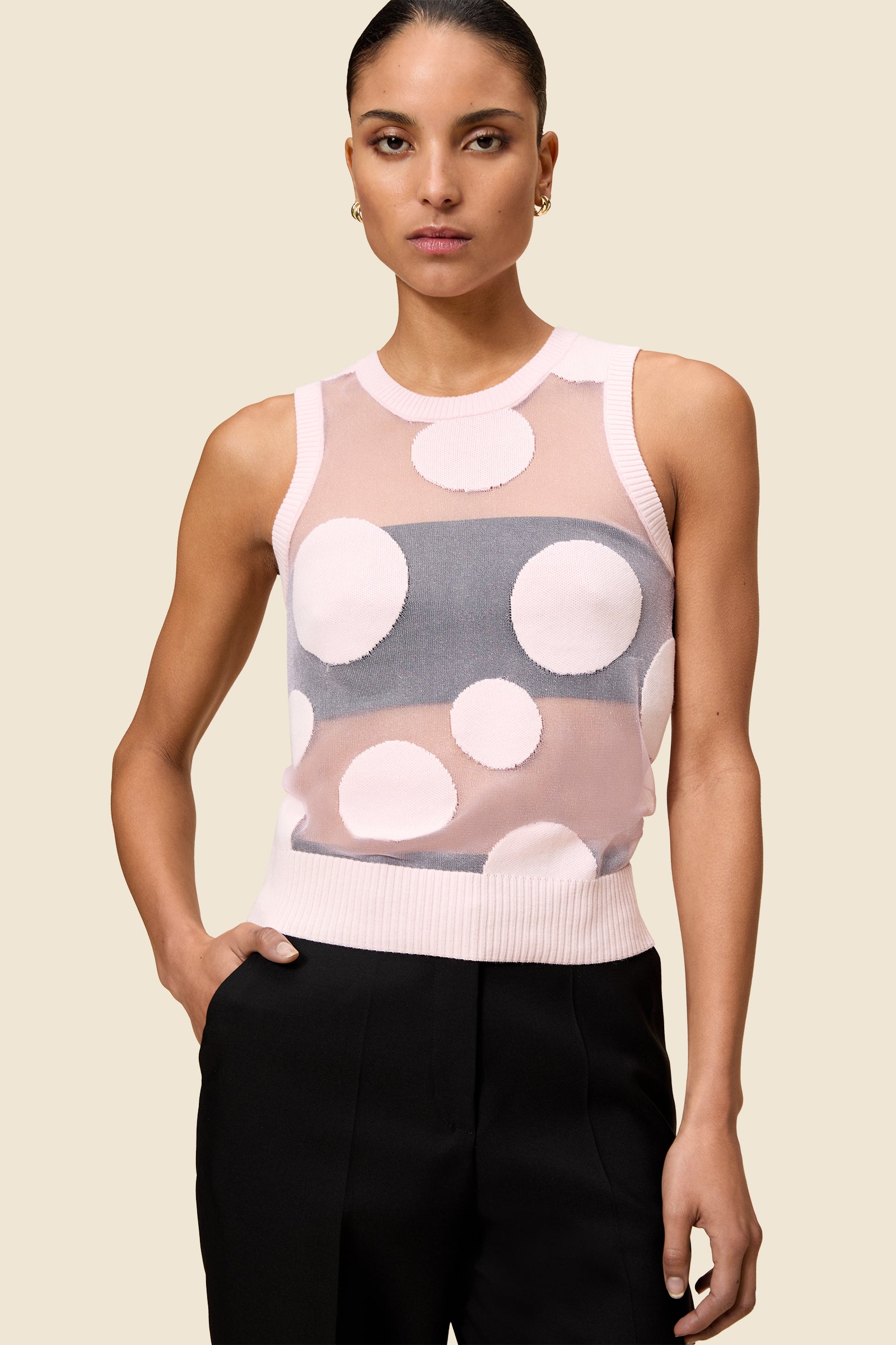 The classic pattern of the top is given a modern twist with intricate polka dot hole design on knit jacquard