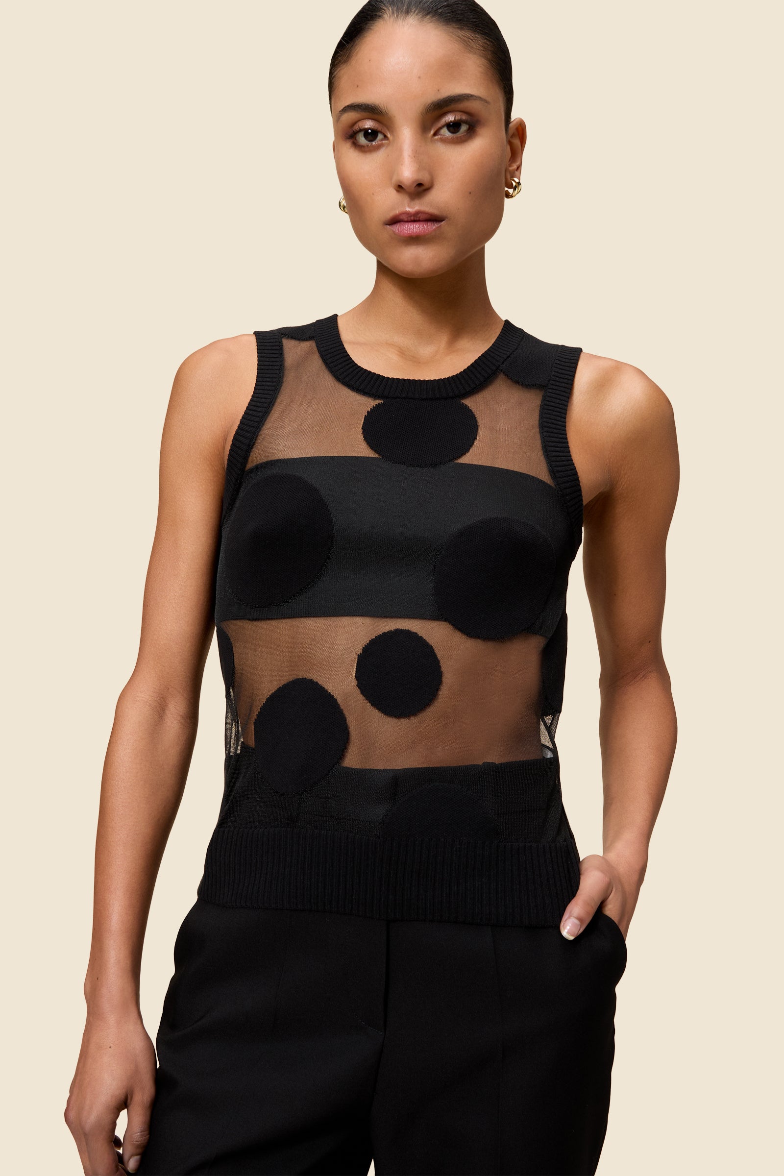 The classic pattern of the top is given a modern twist with intricate polka dot hole design on knit jacquard
