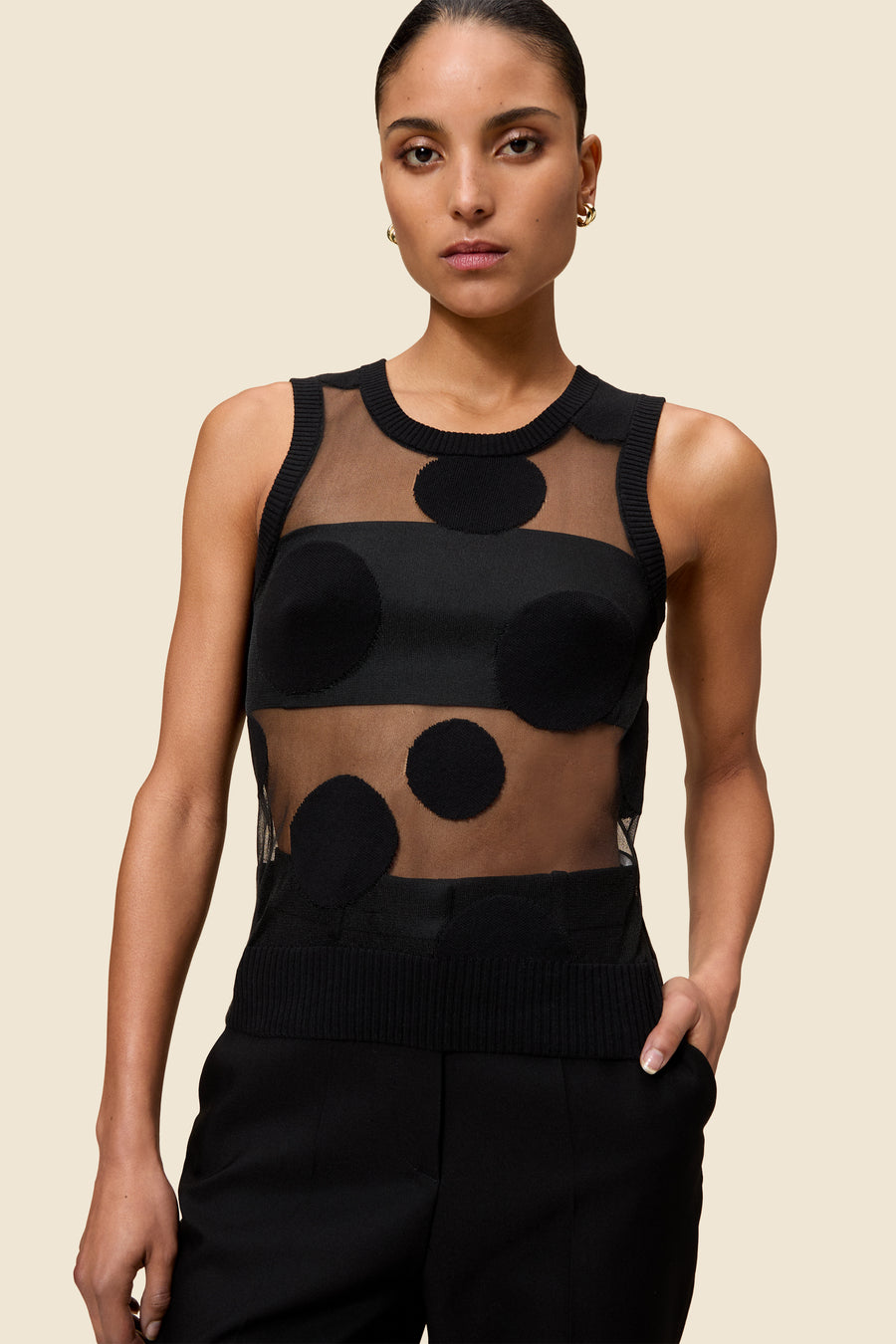 The classic pattern of the top is given a modern twist with intricate polka dot hole design on knit jacquard