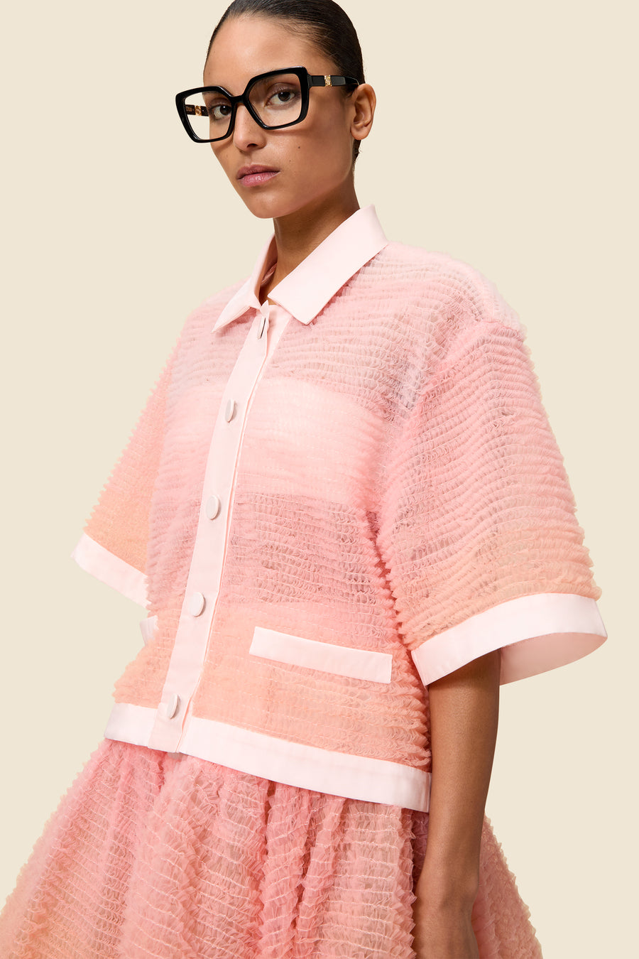 Inspired by the tulle from the ‘late stage capitalism waltz’ haute couture collection, the shirt features hand crafted tulle ruffles for a feminine texture