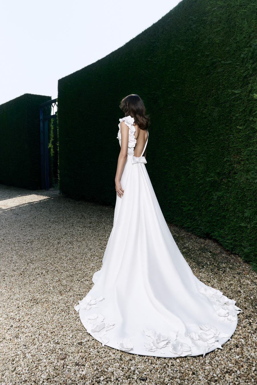 Viktor & Rolf Mariage Bridalwear Collection, Autumn Winter 25, elegant gown with floral detailing and layered ruffles.