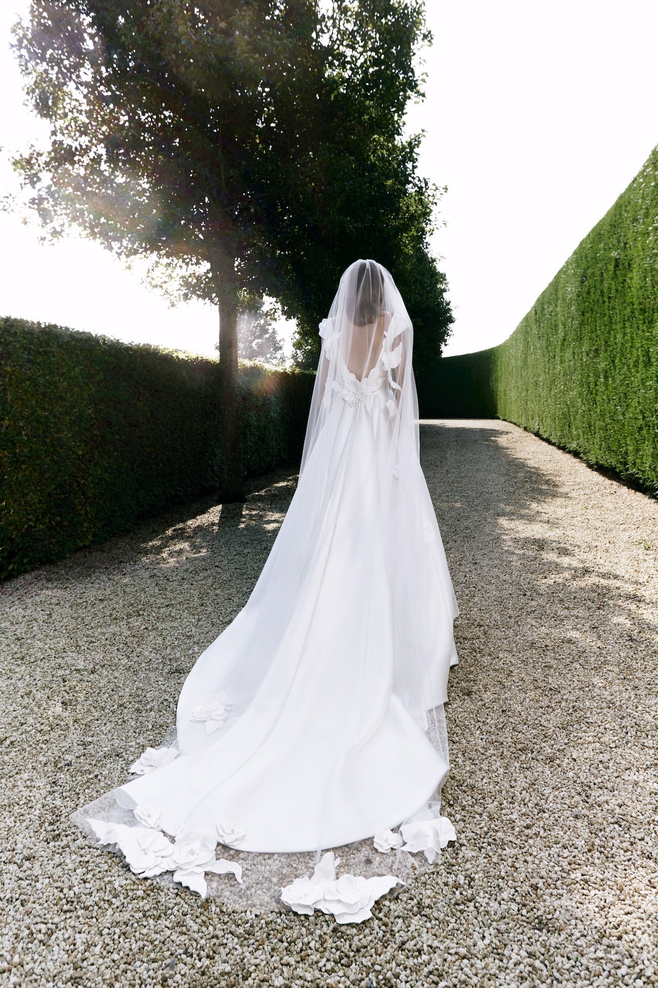 Viktor & Rolf Mariage Bridalwear Collection from Autumn Winter 25, featuring a flowing white gown with floral details.