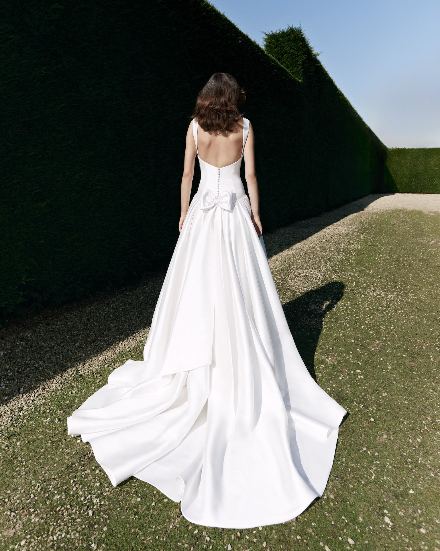 Viktor & Rolf Mariage Bridalwear Collection gown from Autumn Winter 25, featuring elegant back design and flowing silhouette.