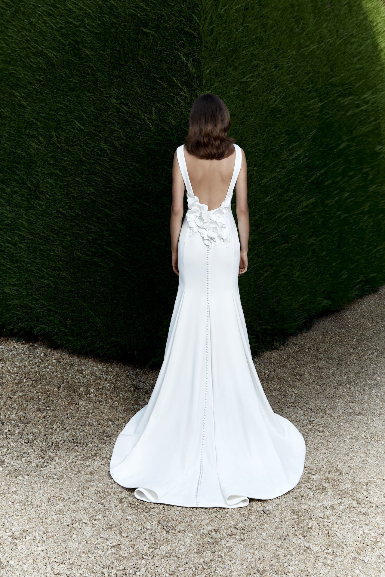 Viktor & Rolf Mariage Bridalwear, Autumn Winter 25 Collection, elegant white gown with floral applique and deep V-back design.