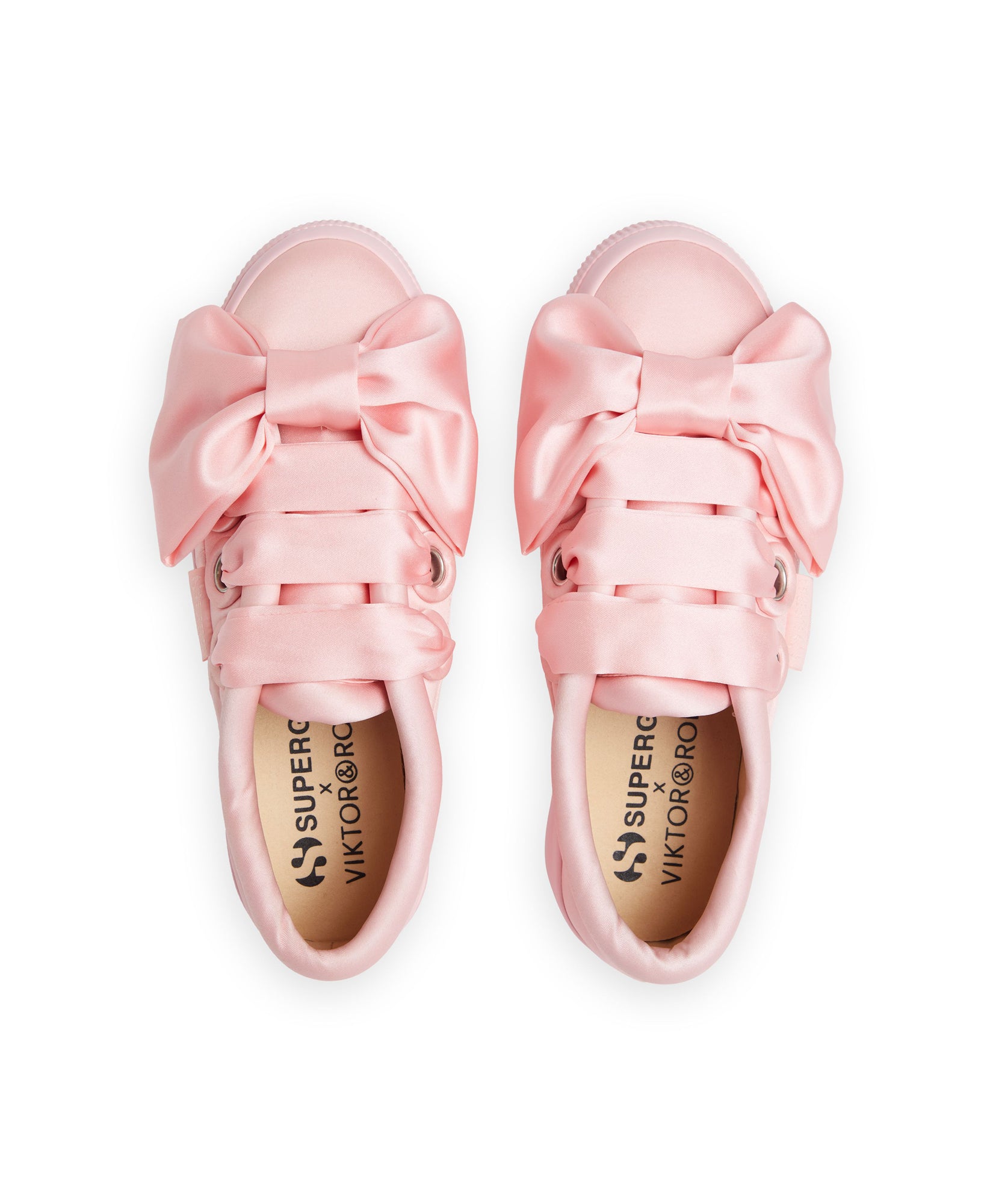 Elegant satin sneakers in soft pink featuring oversized bows, designed by Superga in collaboration with Viktor & Rolf.