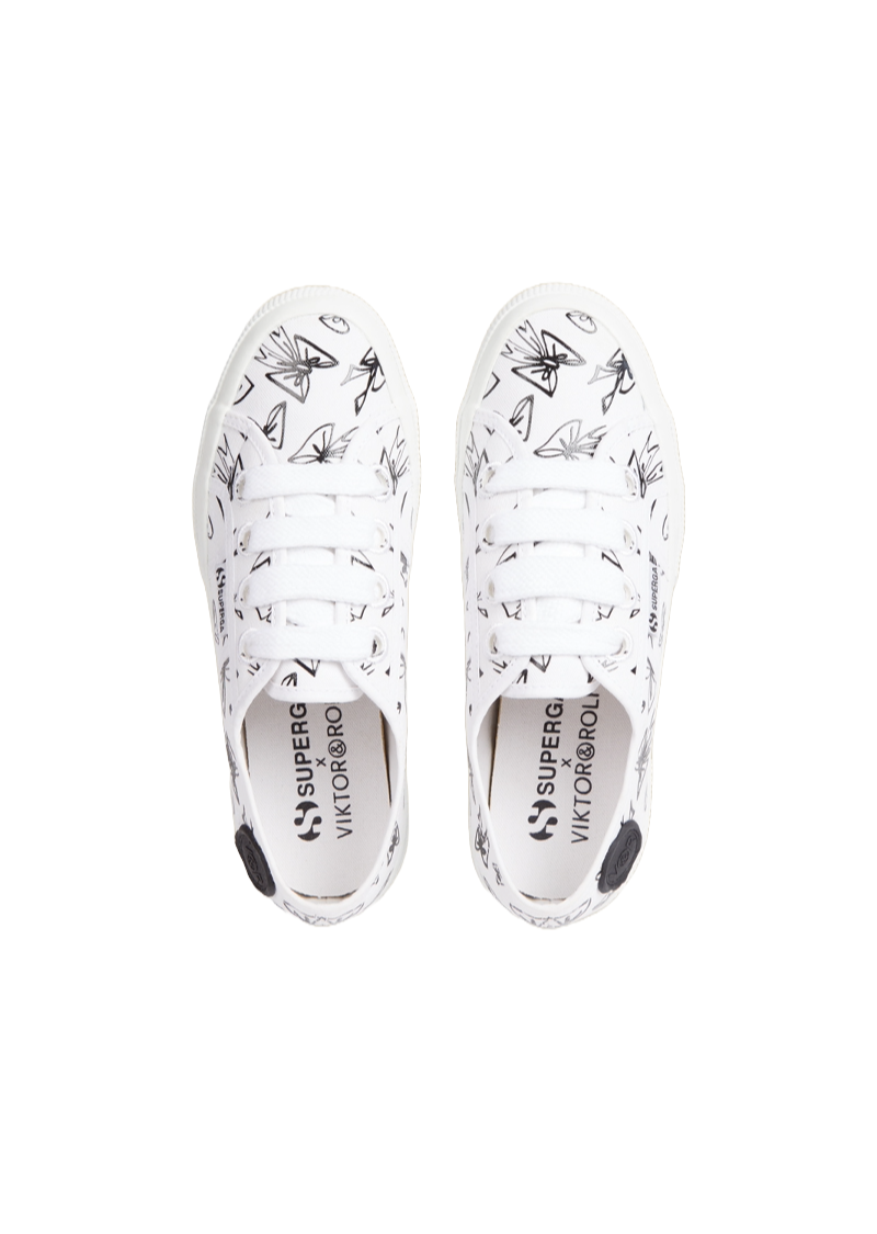 White sneakers featuring abstract black line art pattern with a canvas texture, crafted in collaboration with a designer.