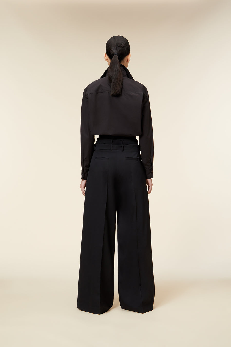 The haute couture "power dressing" inspired multilayered trouser defines utilitarian elegance, seamlessly blending feminine and masculine aesthetics through its tailored silhouette