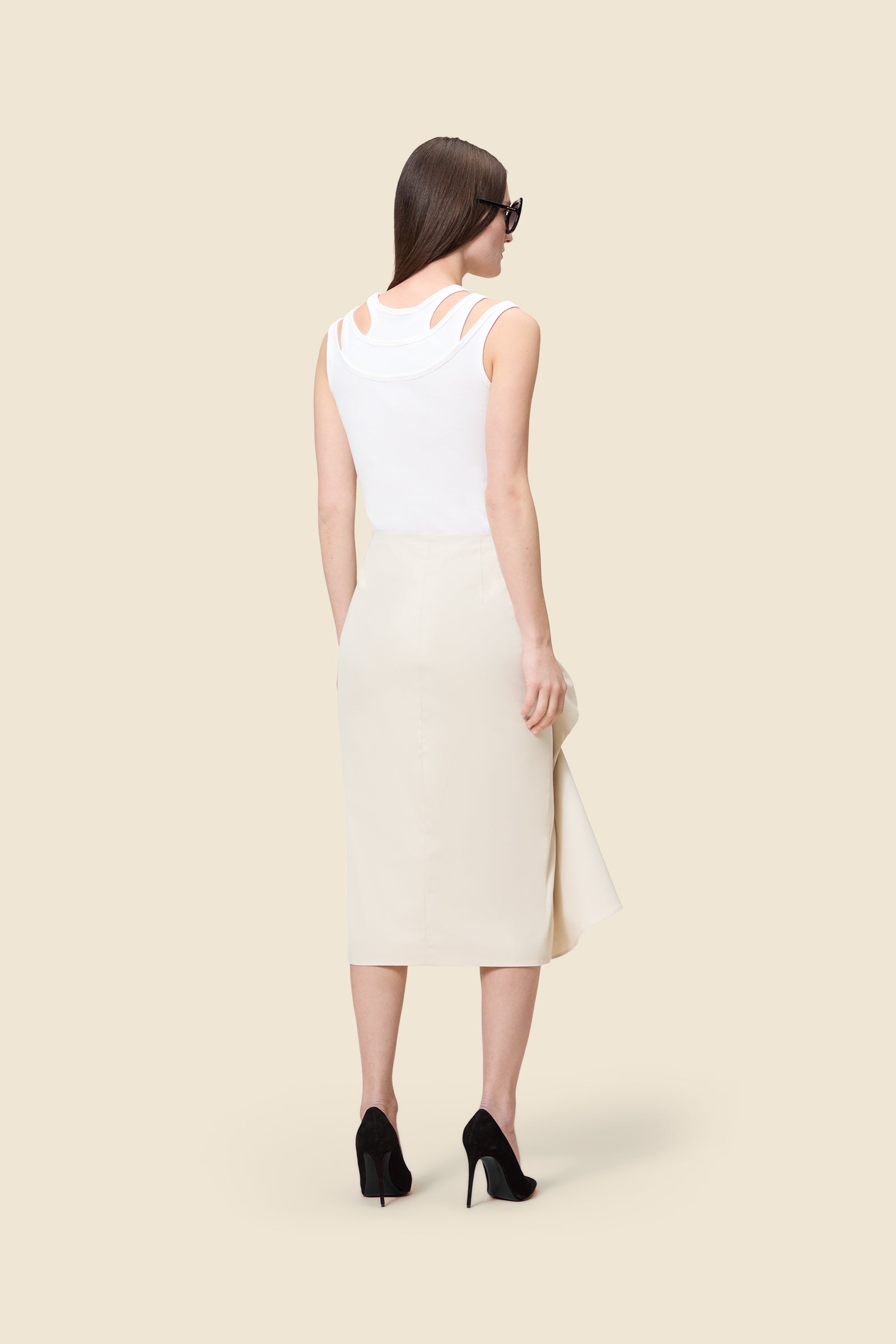 The craftmanship of the skirt reinterprets classic haute couture tuck ups into a modern silhouette from gabardine