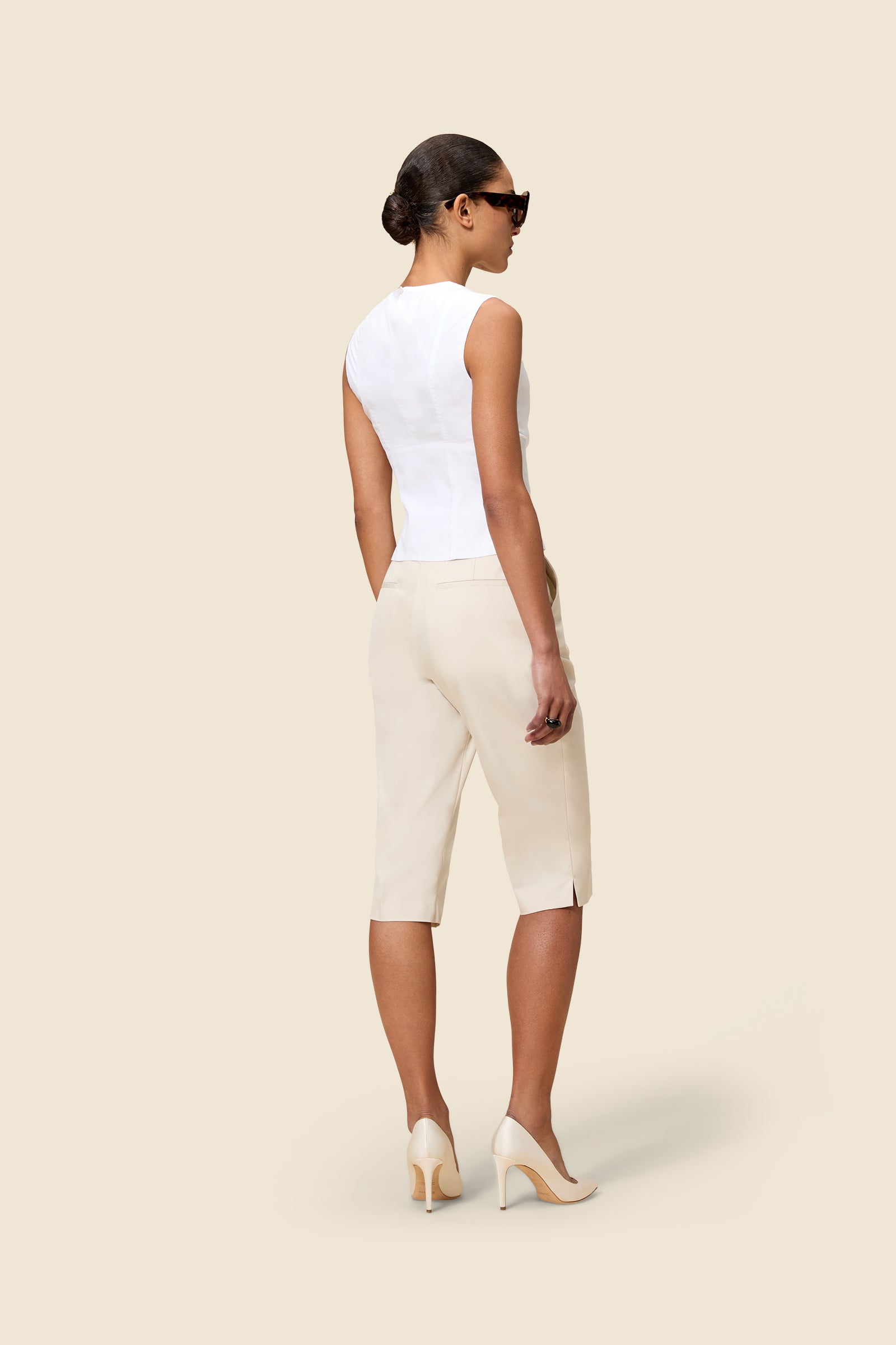 Crafted from gabardine, the high-waisted capri pants offer a tailored fit and timeless elegance