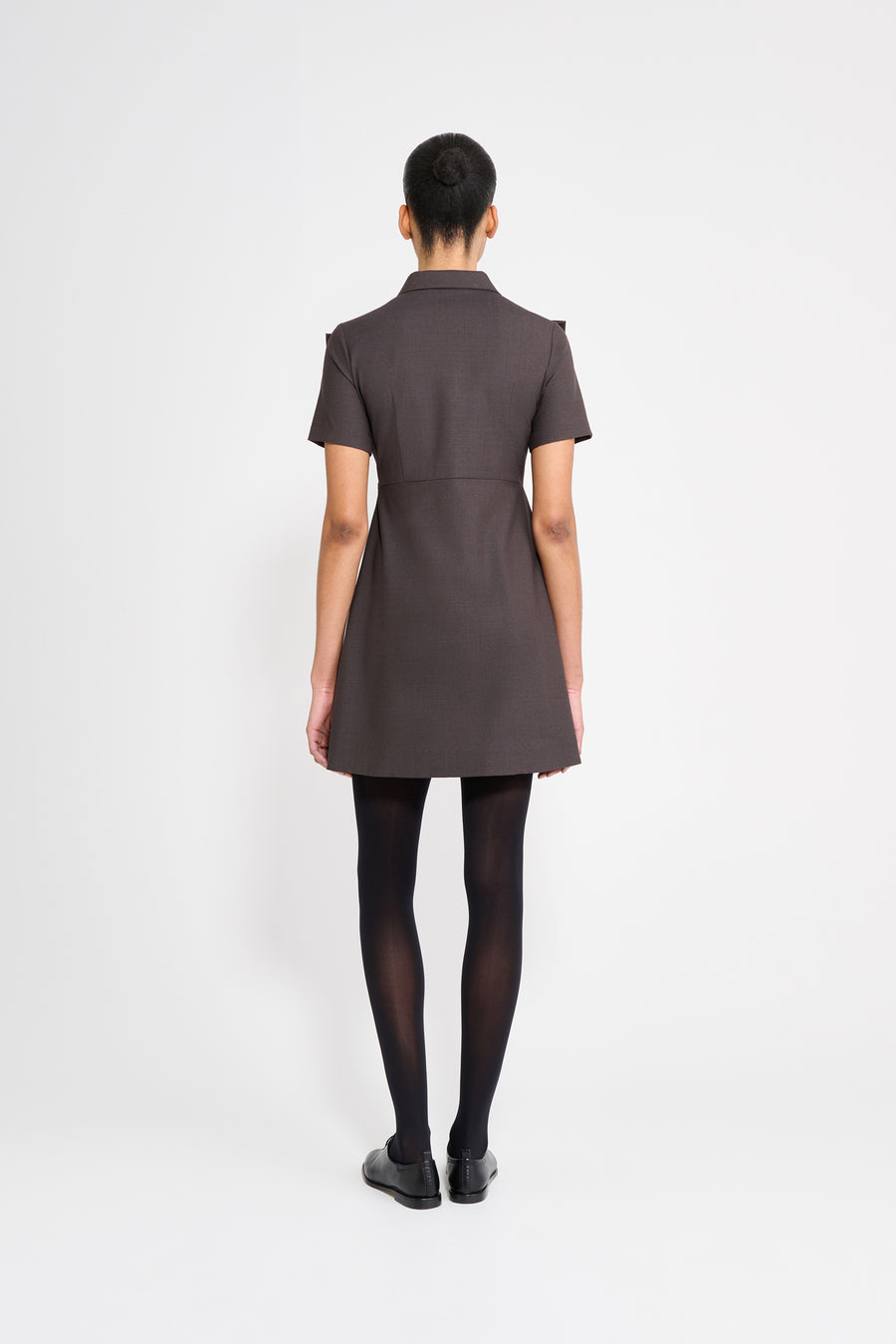 The wool dress features the seasonal bow bouquet technique, where timeless elegance meets refined craftsmanship in a seamless fusion of sophistication and grace