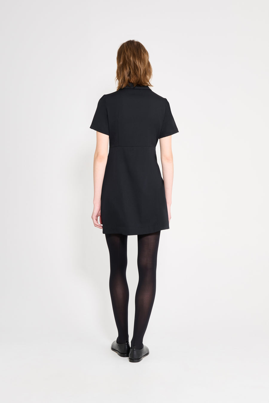 The wool dress features the seasonal bow bouquet technique, where timeless elegance meets refined craftsmanship in a seamless fusion of sophistication and grace