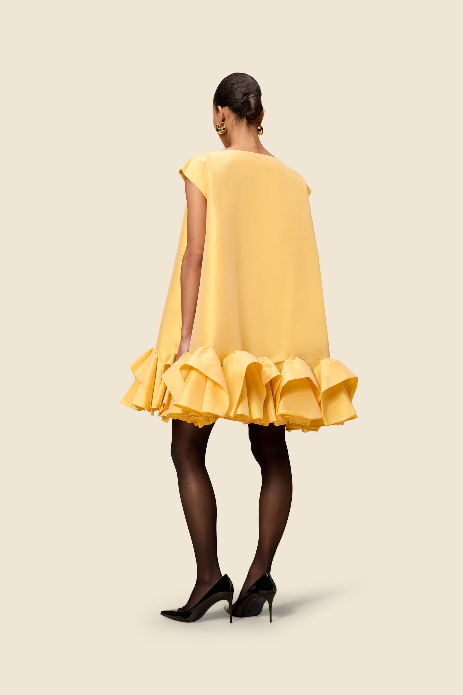 The craftmanship of the dress reinterprets classic haute couture tuck ups into a modern silhouette from silk-blend taffeta