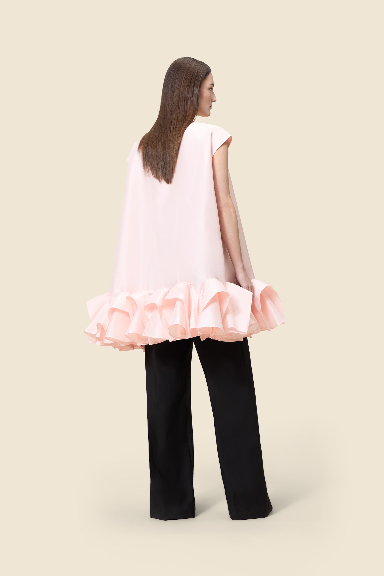 The craftmanship of the dress reinterprets classic haute couture tuck ups into a modern silhouette from silk-blend taffeta