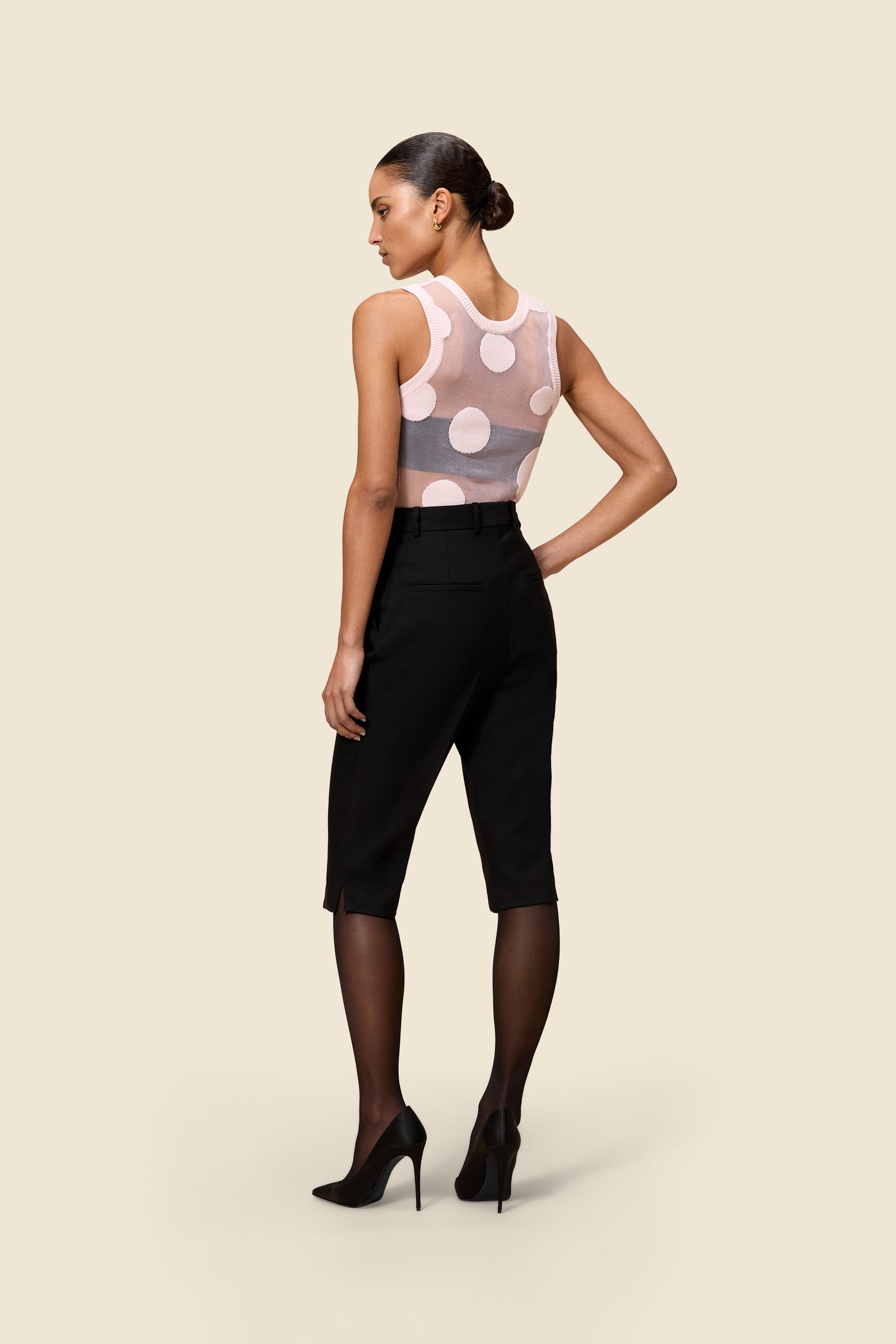 The classic pattern of the top is given a modern twist with intricate polka dot hole design on knit jacquard
