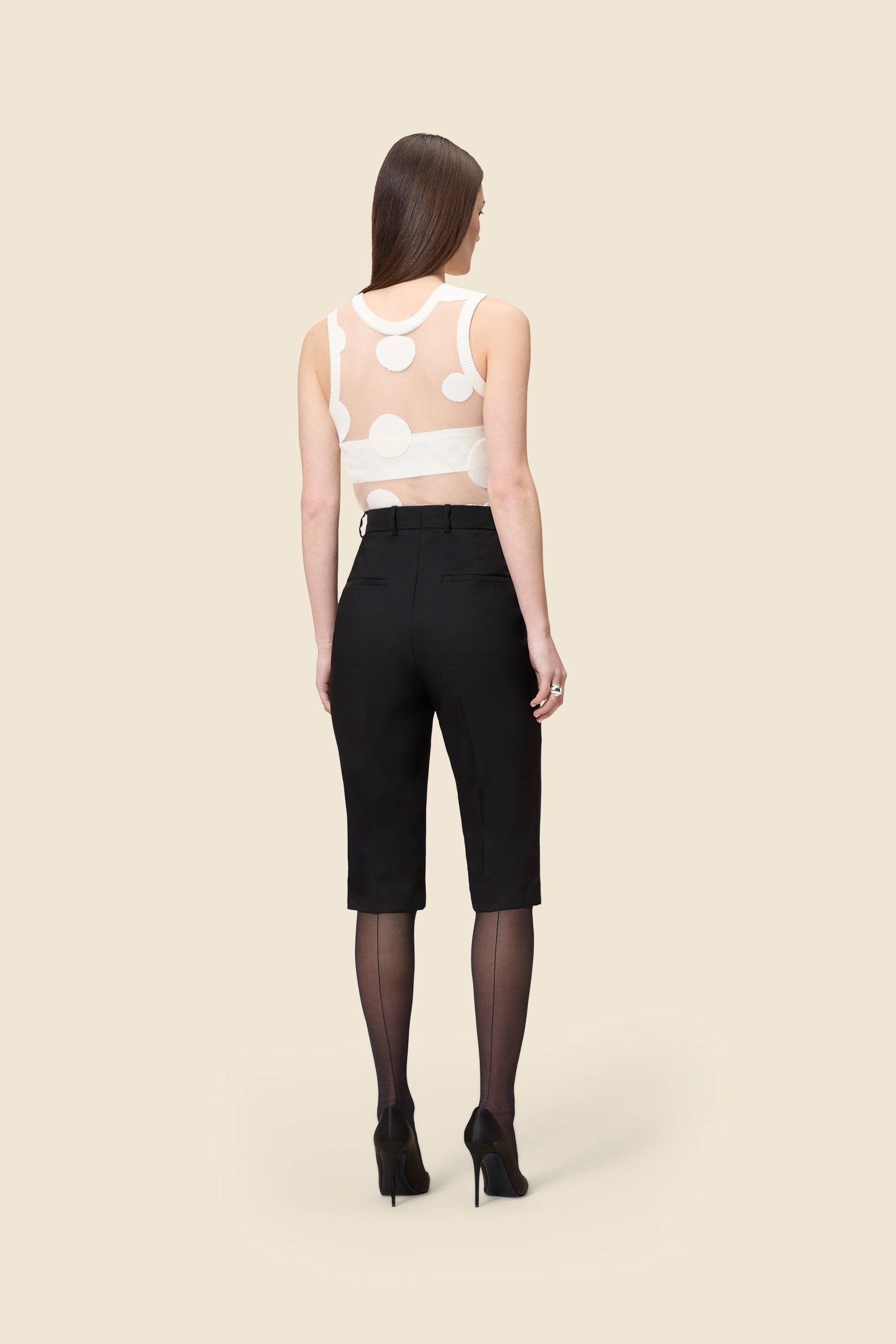 The classic pattern of the top is given a modern twist with intricate polka dot hole design on knit jacquard