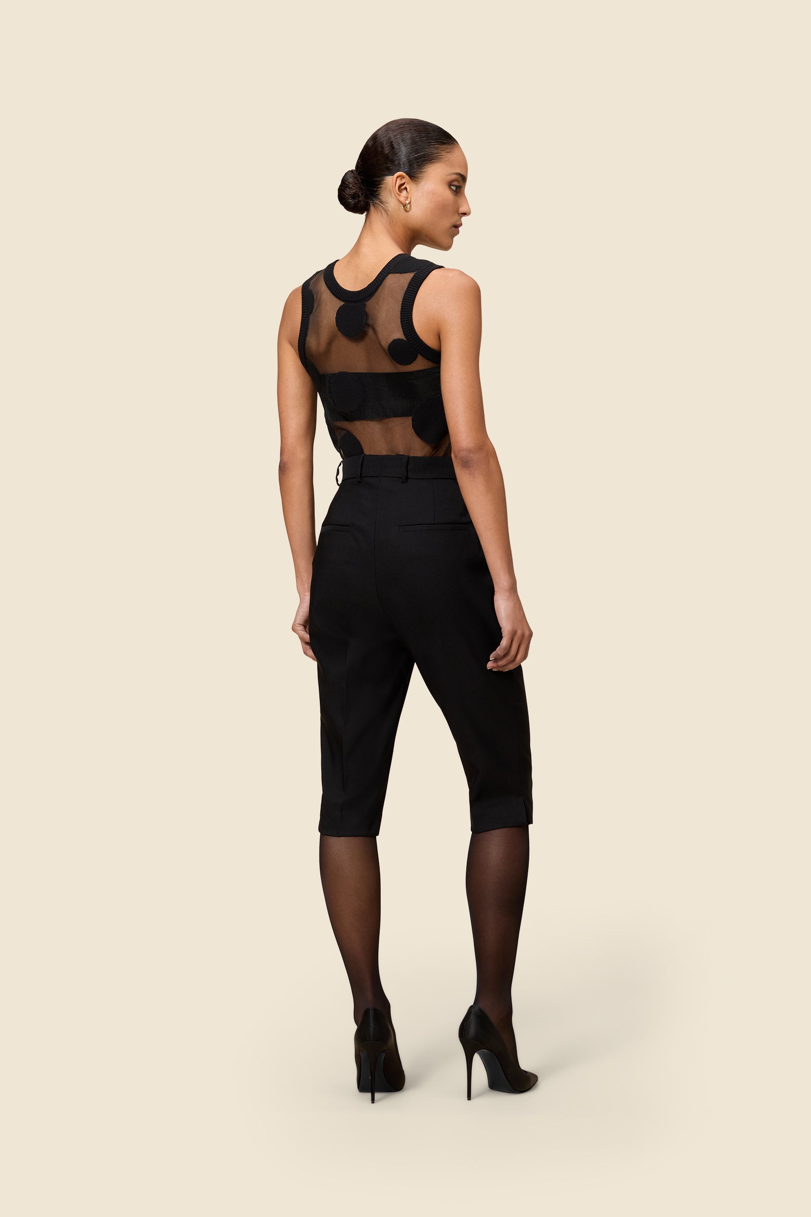 The classic pattern of the top is given a modern twist with intricate polka dot hole design on knit jacquard