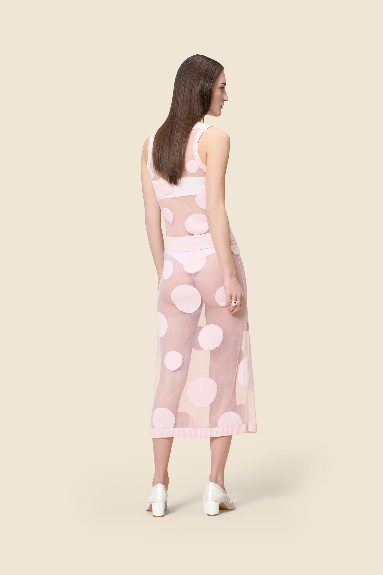 The classic pattern of the skirt is given a modern twist with intricate polka dot hole design on knit jacquard