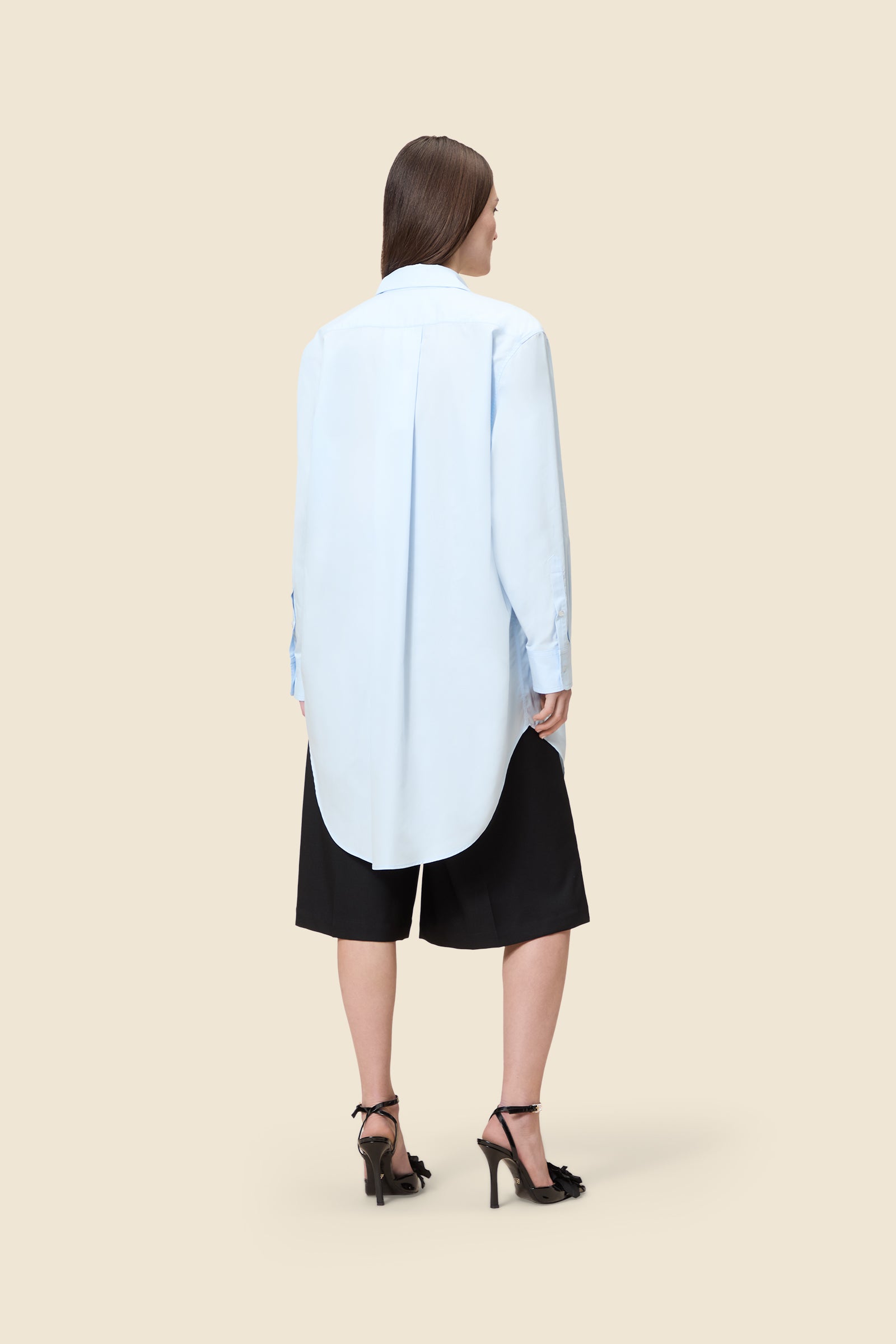 Crafted from poplin, the oversized shirt offers a tailored fit and timeless elegance