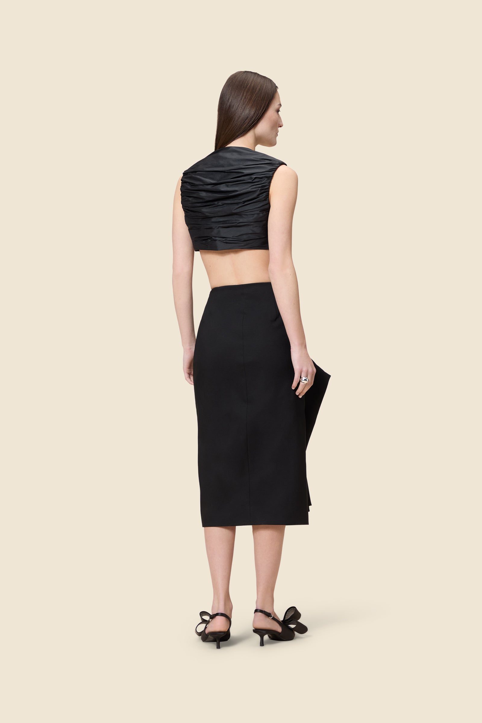 The meticulously placed pleats and silk-blend taffeta define the elegance of the top, reflecting classic haute couture craftsmanship with a modern edge