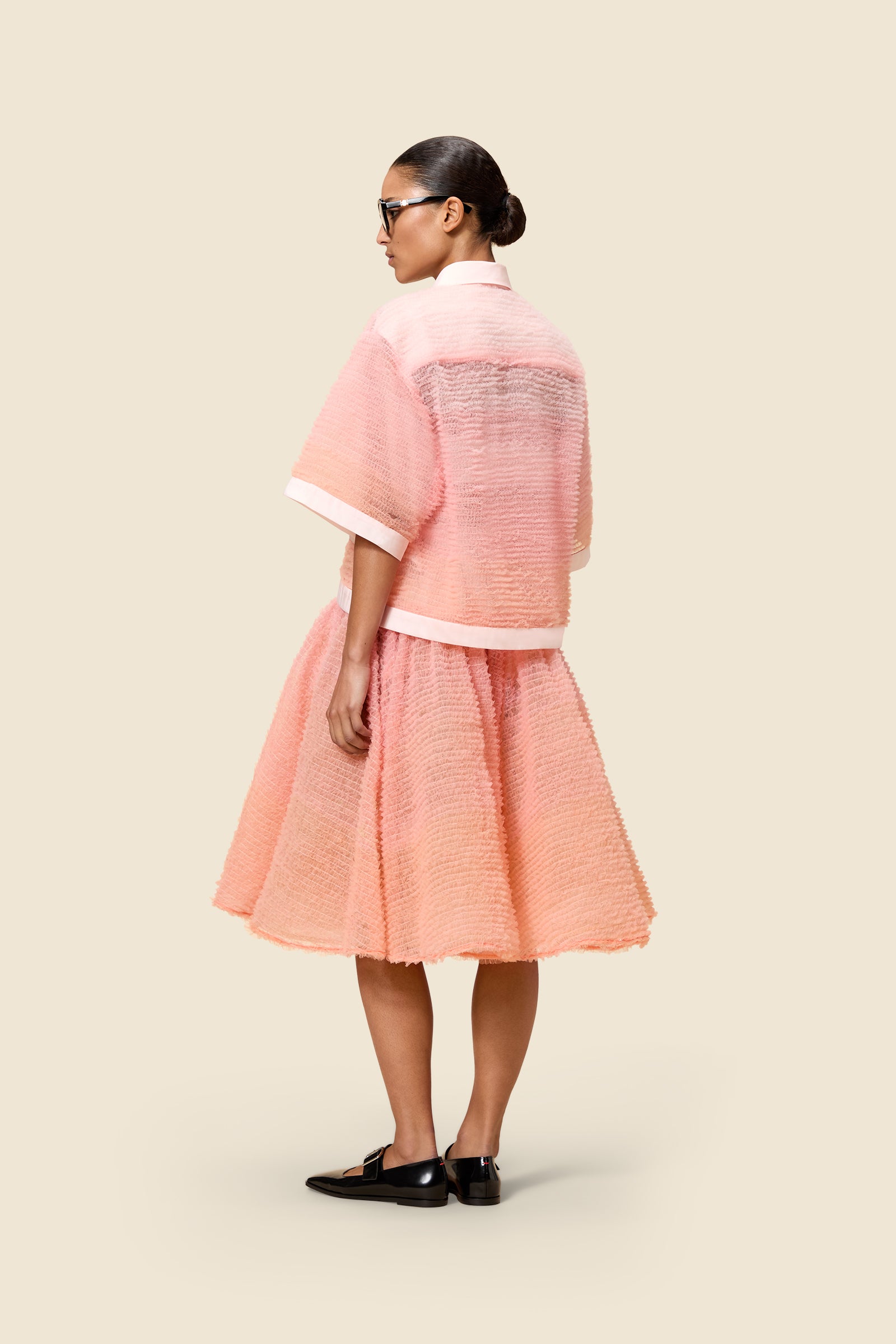 Inspired by the tulle from the ‘late stage capitalism waltz’ haute couture collection, the shirt features hand crafted tulle ruffles for a feminine texture