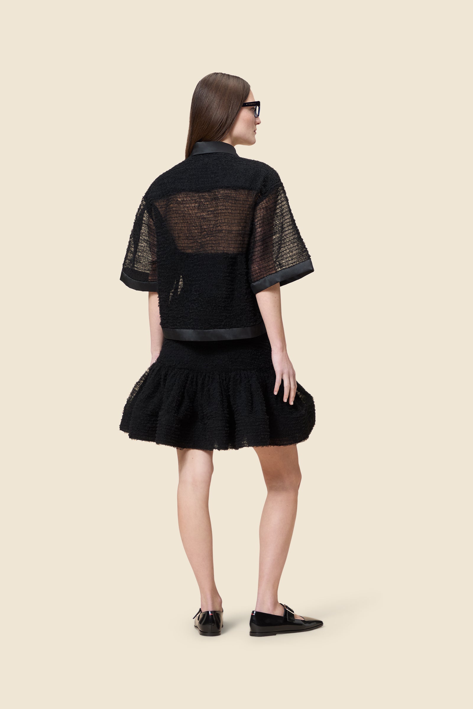 Inspired by the tulle from the ‘late stage capitalism waltz’ haute couture collection, the shirt features hand crafted tulle ruffles for a feminine texture