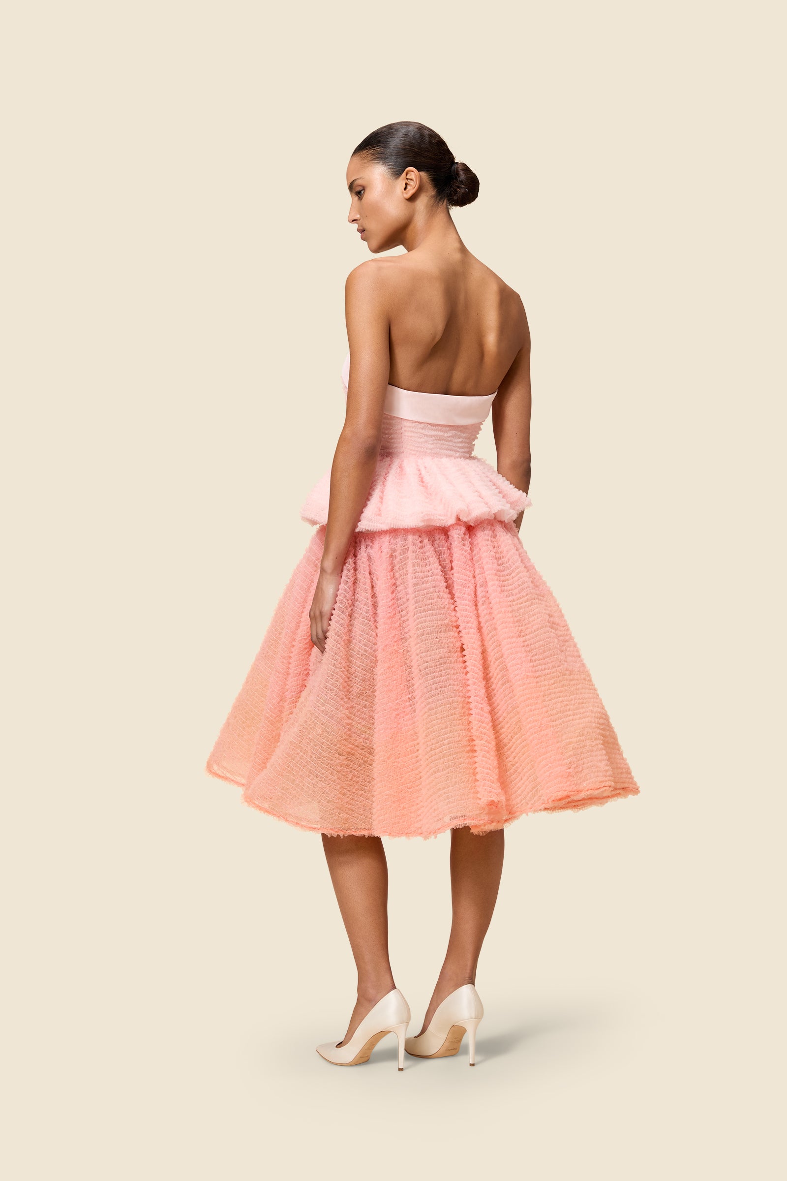 Inspired by the tulle from the ‘late stage capitalism waltz’ haute couture collection, the top features hand crafted tulle ruffles for a feminine texture