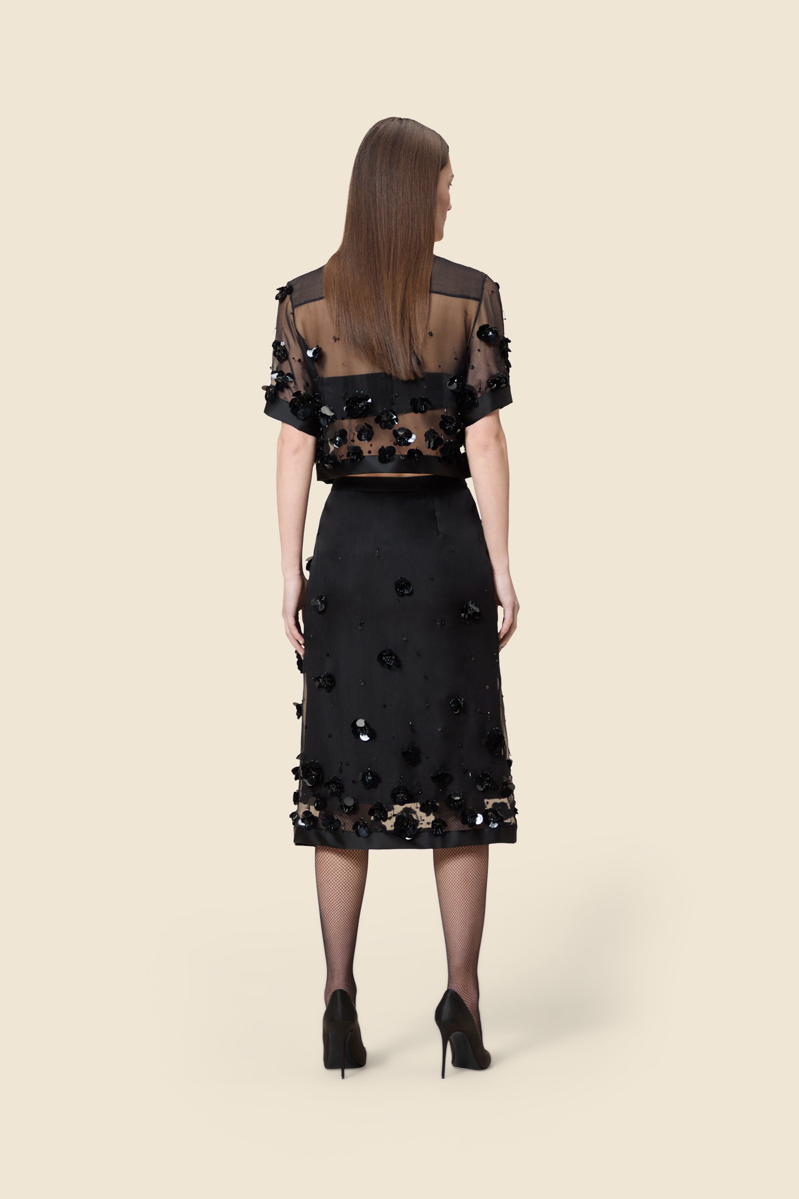With hand-applied paillettes and crystals on silk organza featuring the satin edges, the skirt transforms classic floral embroidery into a modern piece