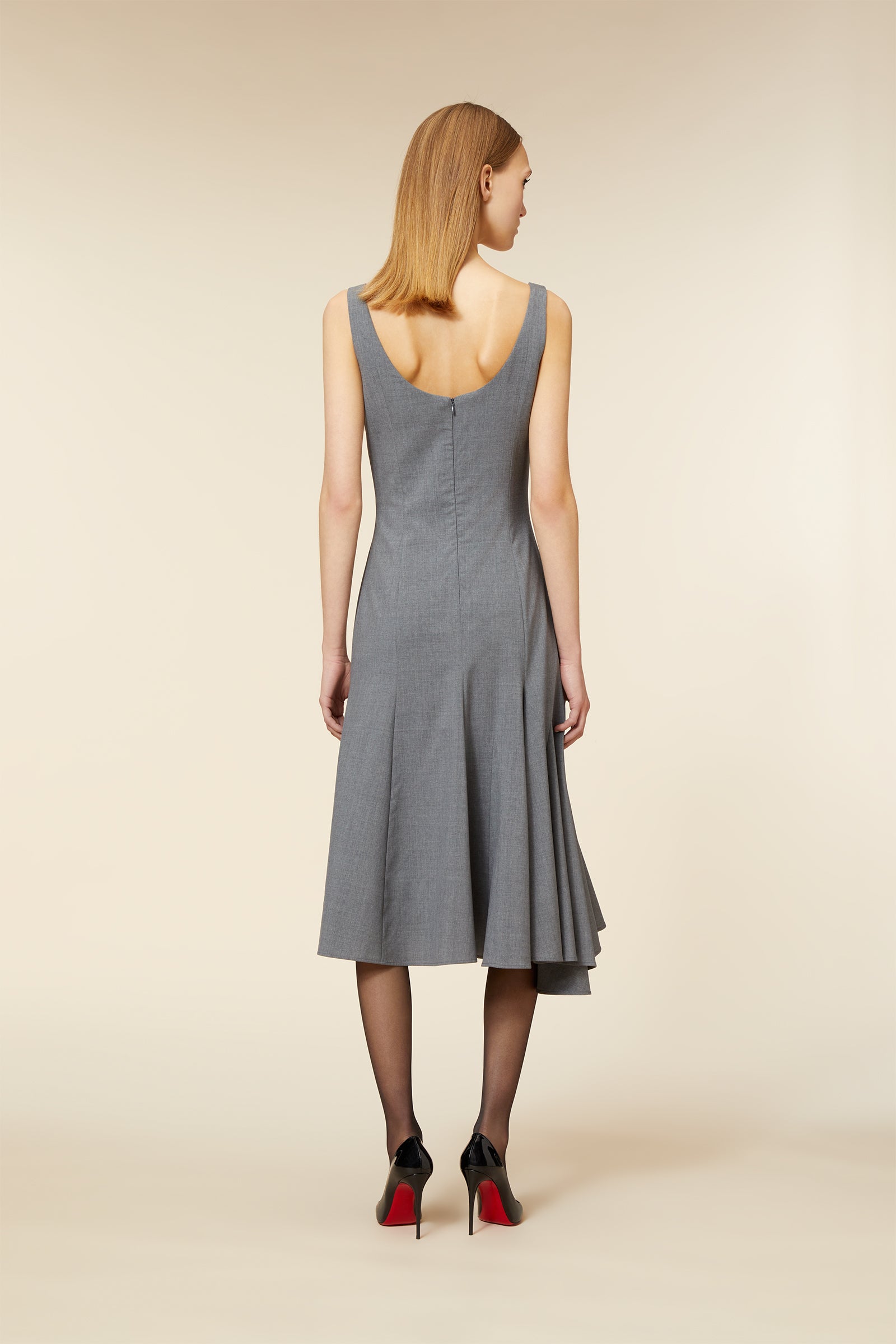 Sleeveless grey dress features a flared skirt and elegant scoop back design, showcasing a refined and timeless silhouette.