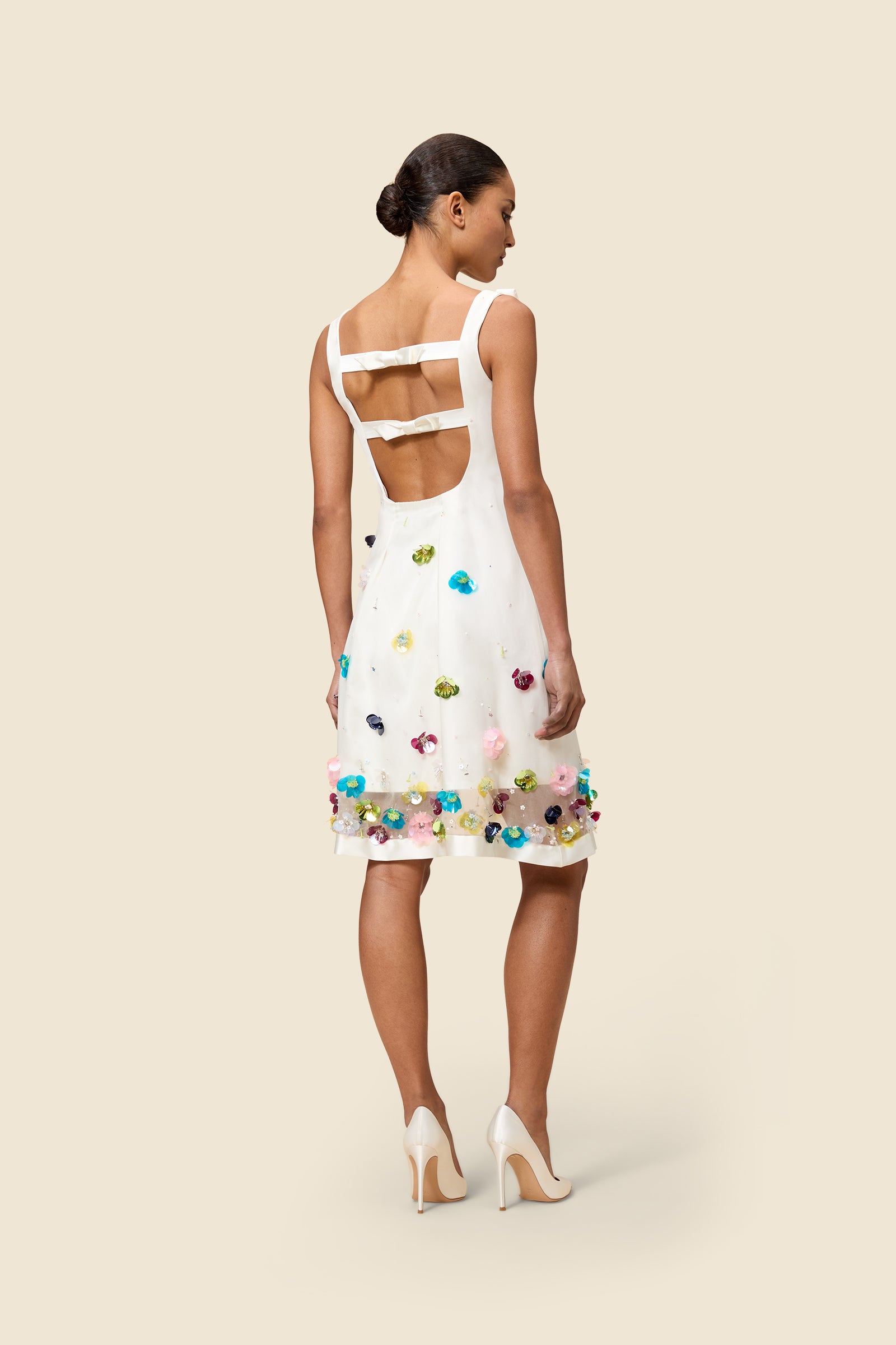 With hand-applied paillettes and crystals on silk organza featuring the satin edges, the dress transforms classic floral embroidery into a modern piece
