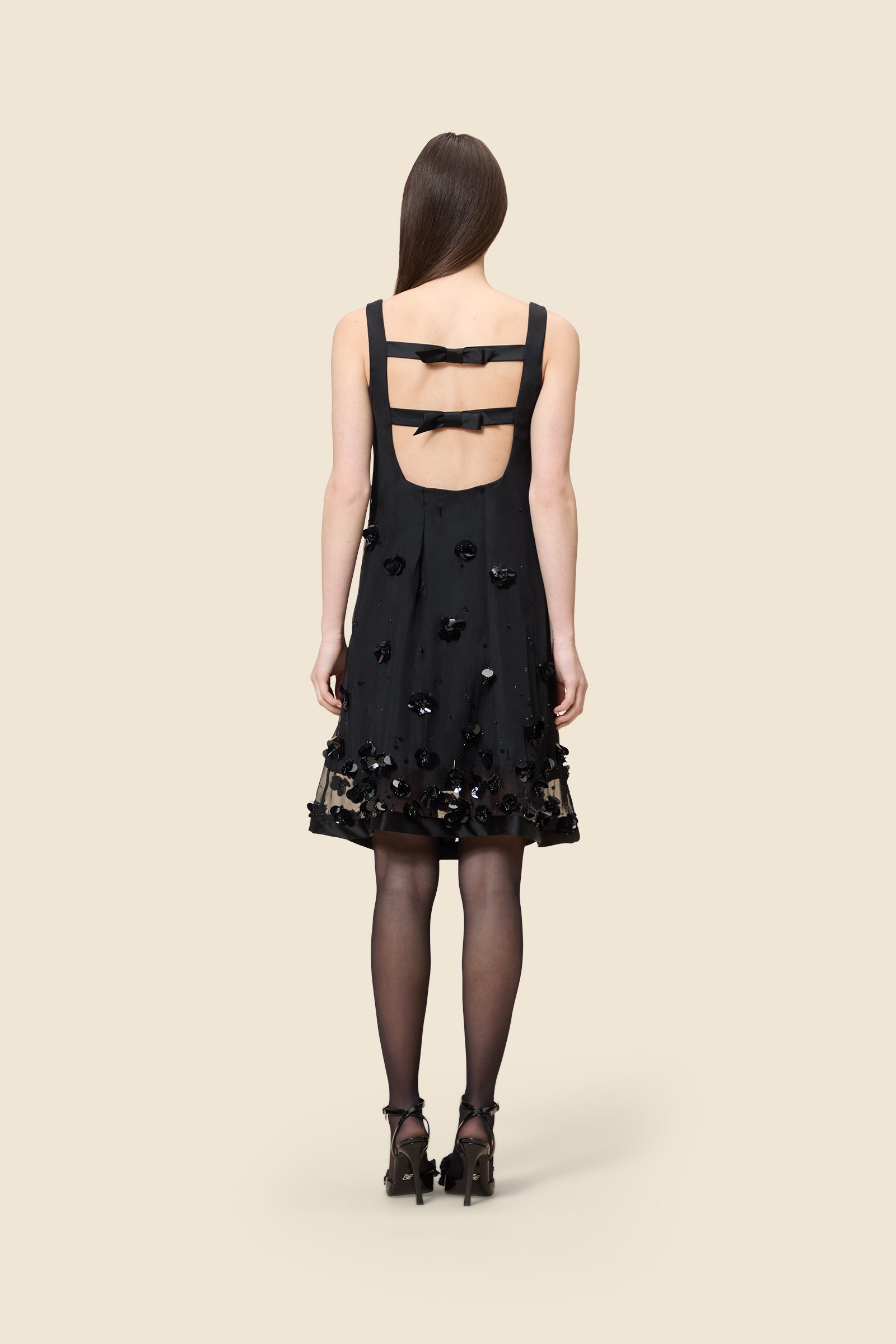 With hand-applied paillettes and crystals on silk organza featuring the satin edges, the dress transforms classic floral embroidery into a modern piece