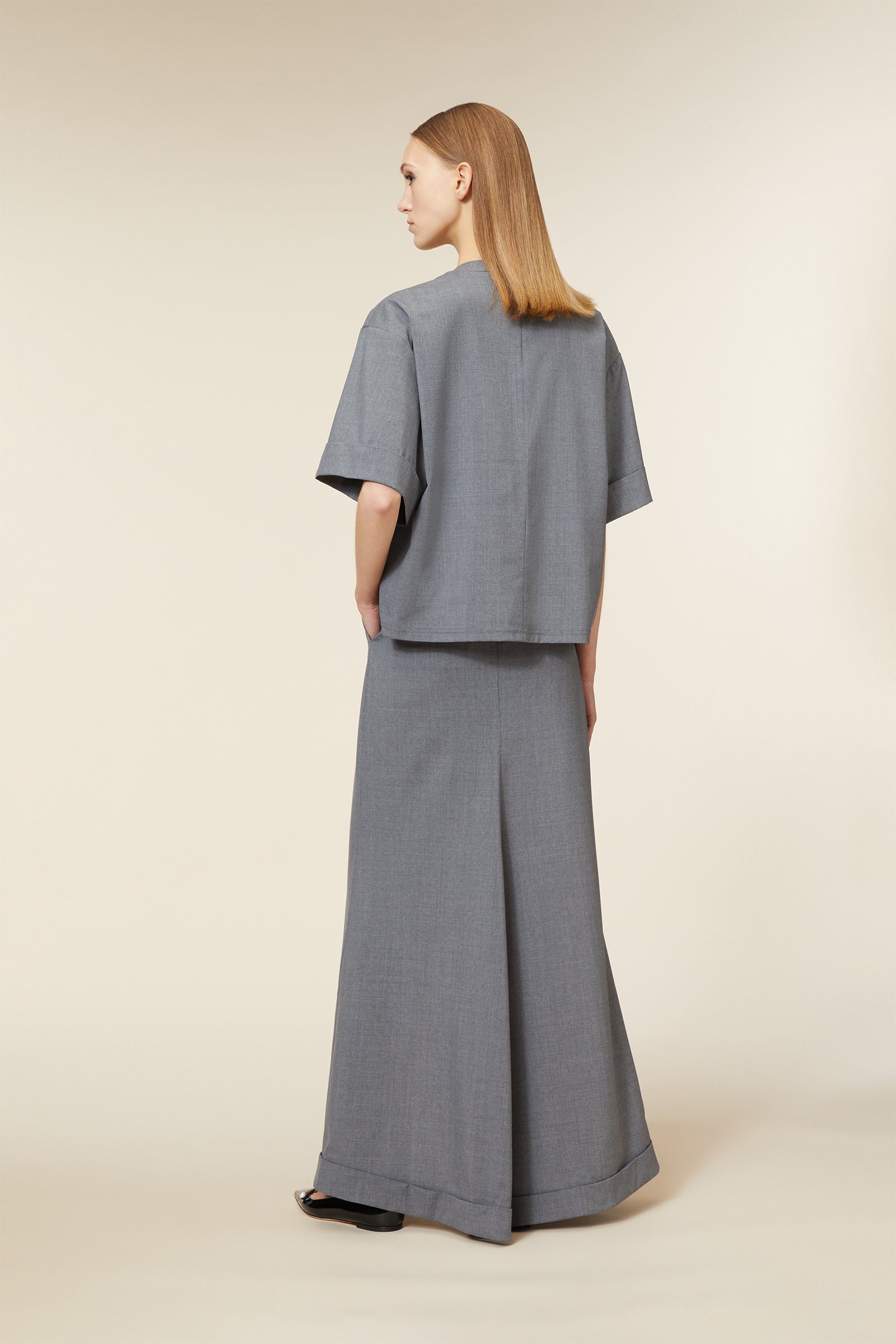A stylish gray ensemble features a wide-legged maxi skirt and a loose-fit short-sleeved jacket in soft wool blend fabric.