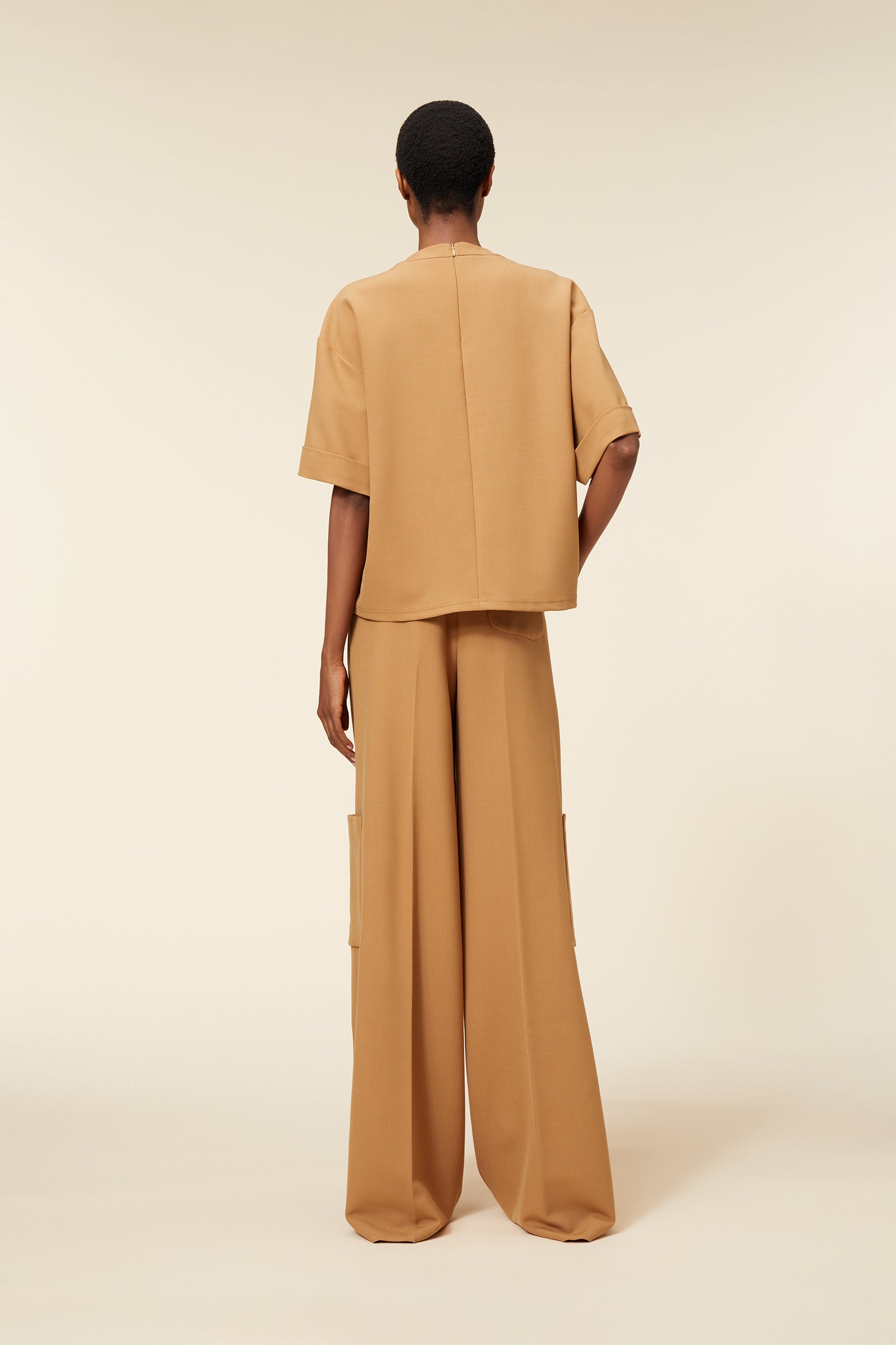 Beige oversized two-piece outfit with loose sleeves and wide-leg pants, designed for a comfortable and stylish fit.