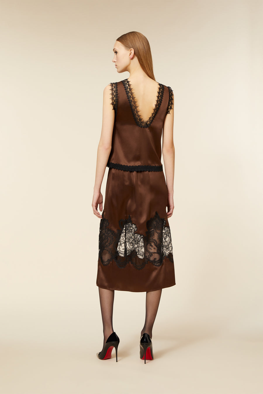 Inspired by the couture "haute fantaisie" collection, the top showcases intricate lace detailing, symbolizing elegance and sophistication