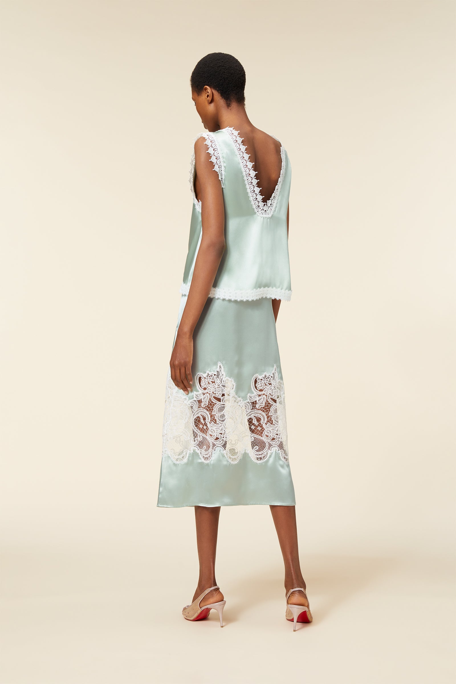 Elegant satin ensemble with delicate lace trim features a deep V-neck and intricate lace inset, creating a sophisticated silhouette.