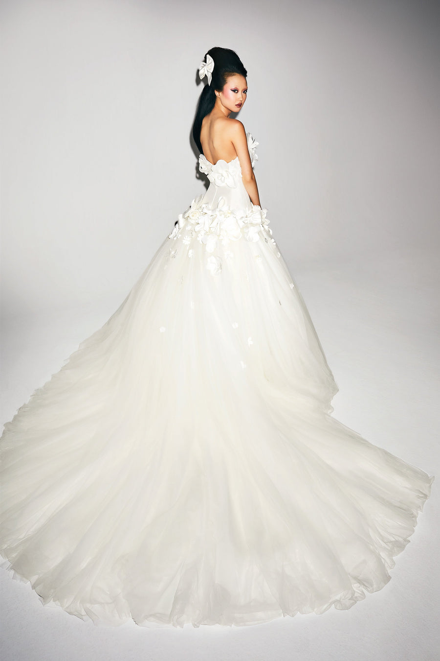 Sophisticated ballgown adorned with mikado ‘abundance fantaisie’ flowers and couture bows edged around the strapless bodice