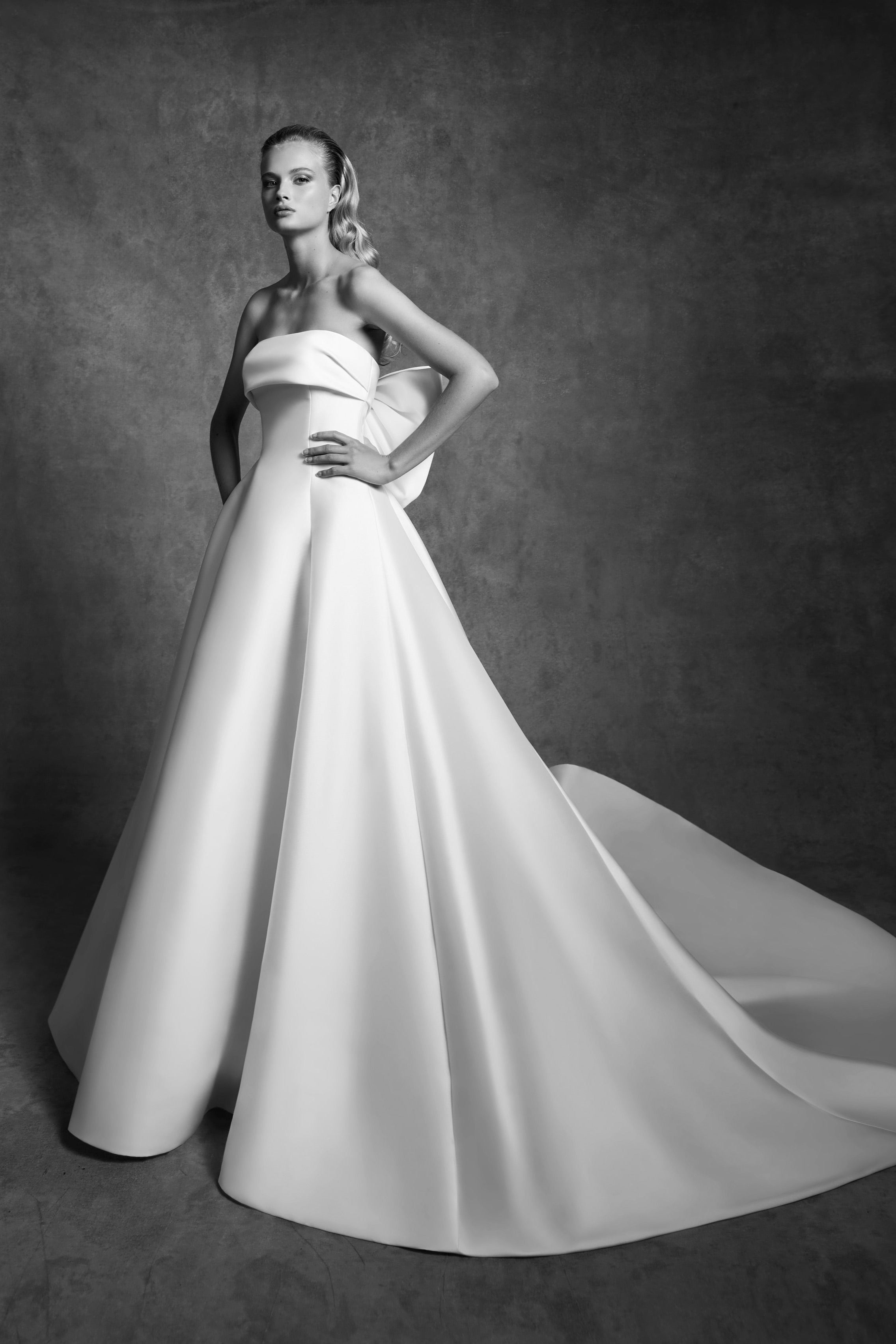 Graphic, strapless a-line dress with a clean band that leads way to an oversized signature viktor&rolf bow to create back interest